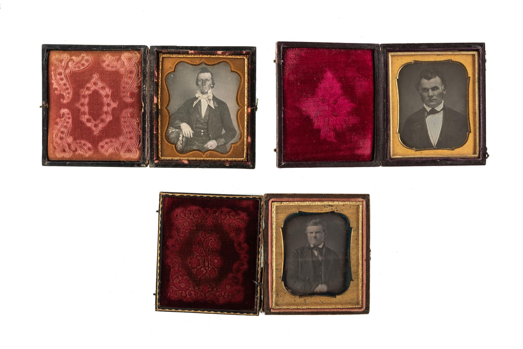 [EARLY PHOTOGRAPHY - PORTRAITURE]. A group of 7 daguerreotype and ambrotype portraits of men, many with interesting and unusual expressions and features, highlighted by full plate ambrotype of group of distinguished gents.
