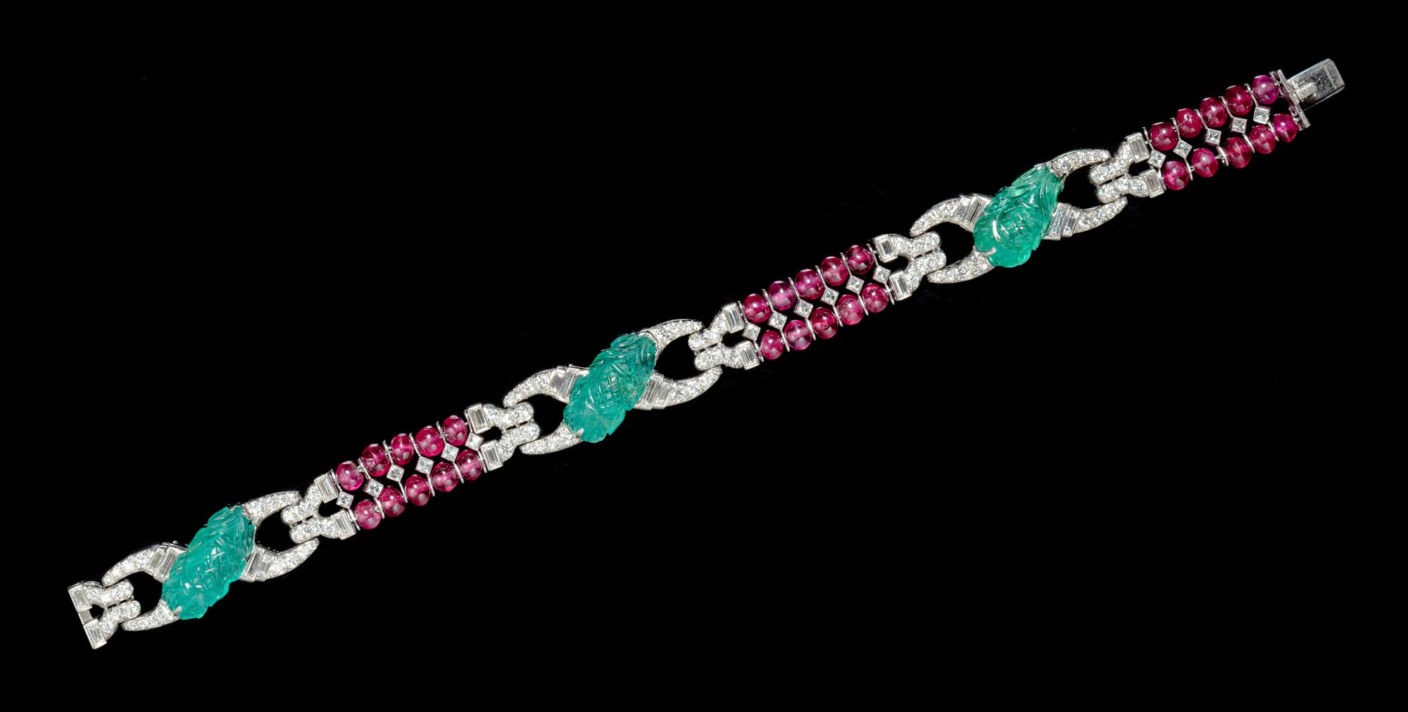 A Fine Art Deco Platinum, Diamond, Carved Emerald and Ruby Bead Bracelet, 22.30 dwts.