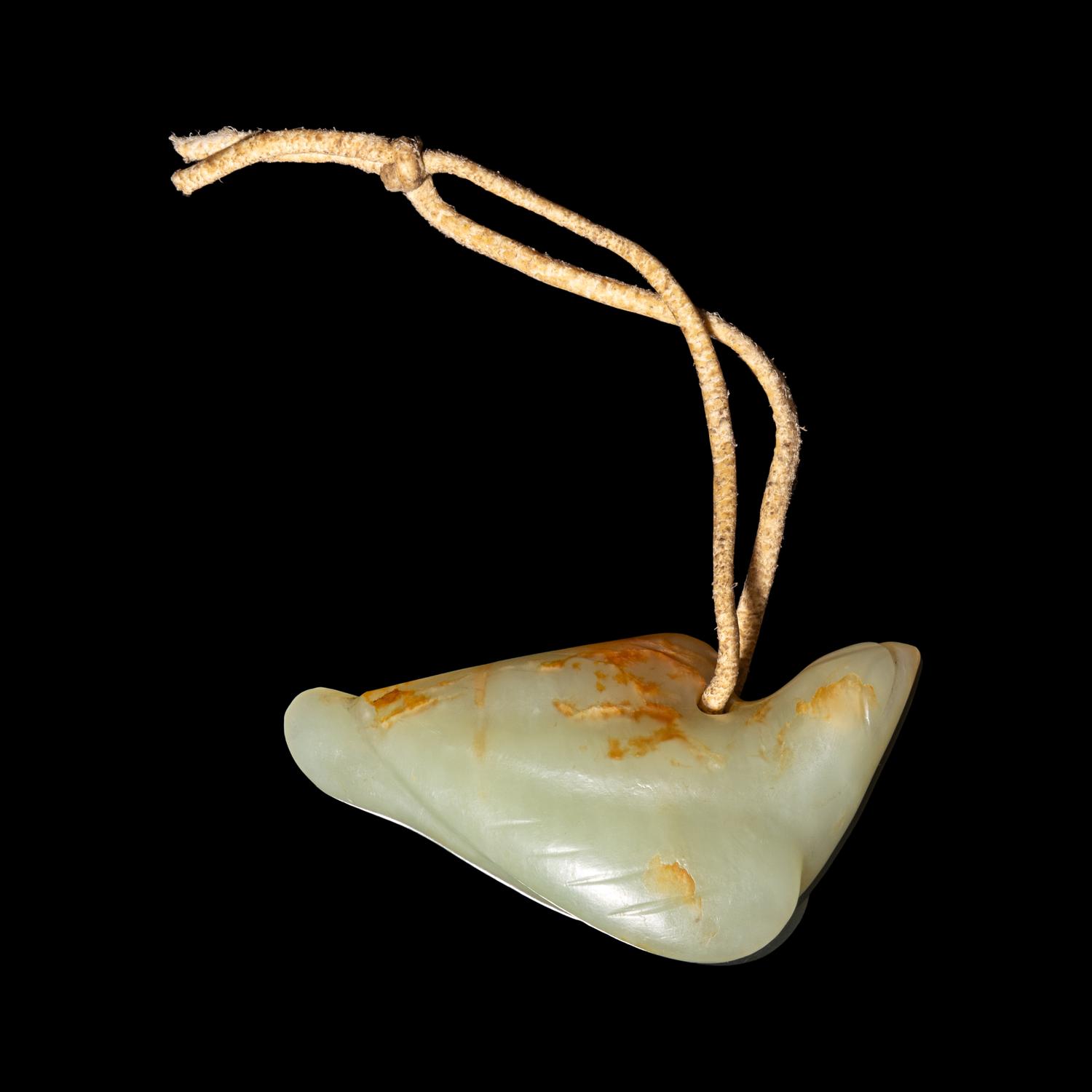 A Chinese Russet and Celadon Jade Carving of a Bird, Possibly Ming Dynasty 明 青白玉鳥