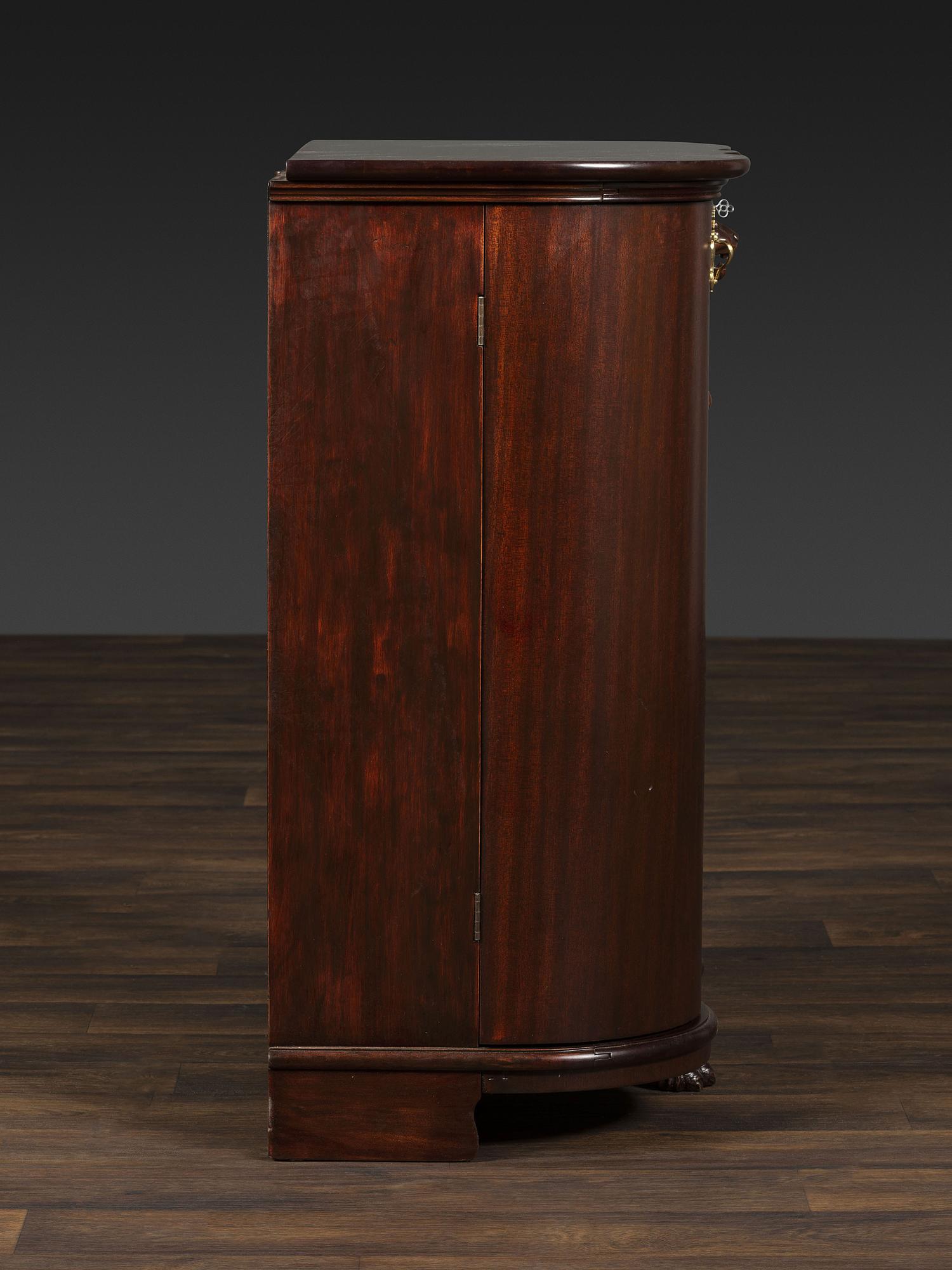A Salter Double Bow-Front Lion Mask Carved Mahogany Record Cabinet