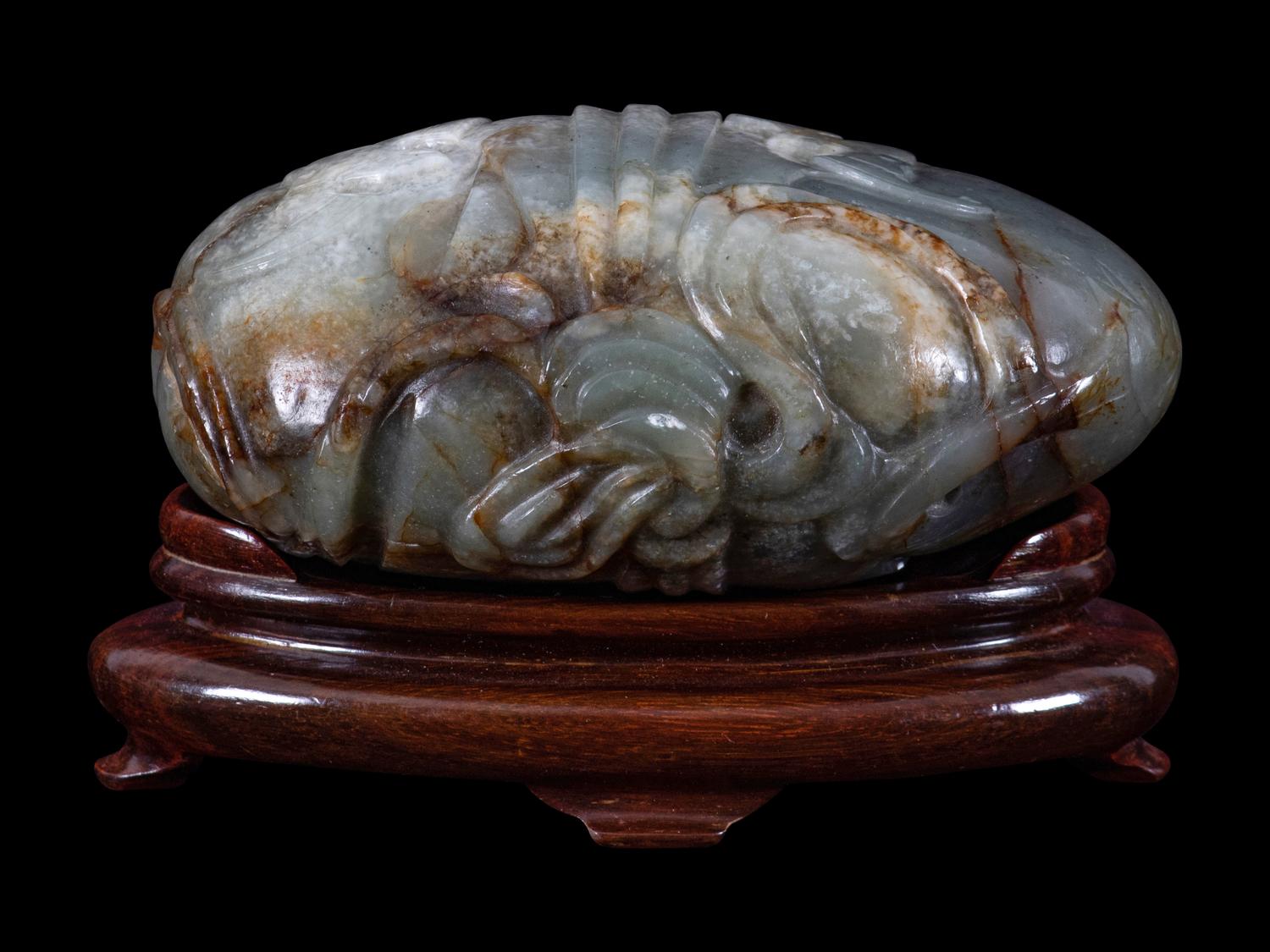 A Grey and Russet Jade Purse-Form Paperweight