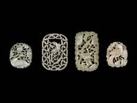 Four Chinese White and Celadon Jade Reticulated Pendants
