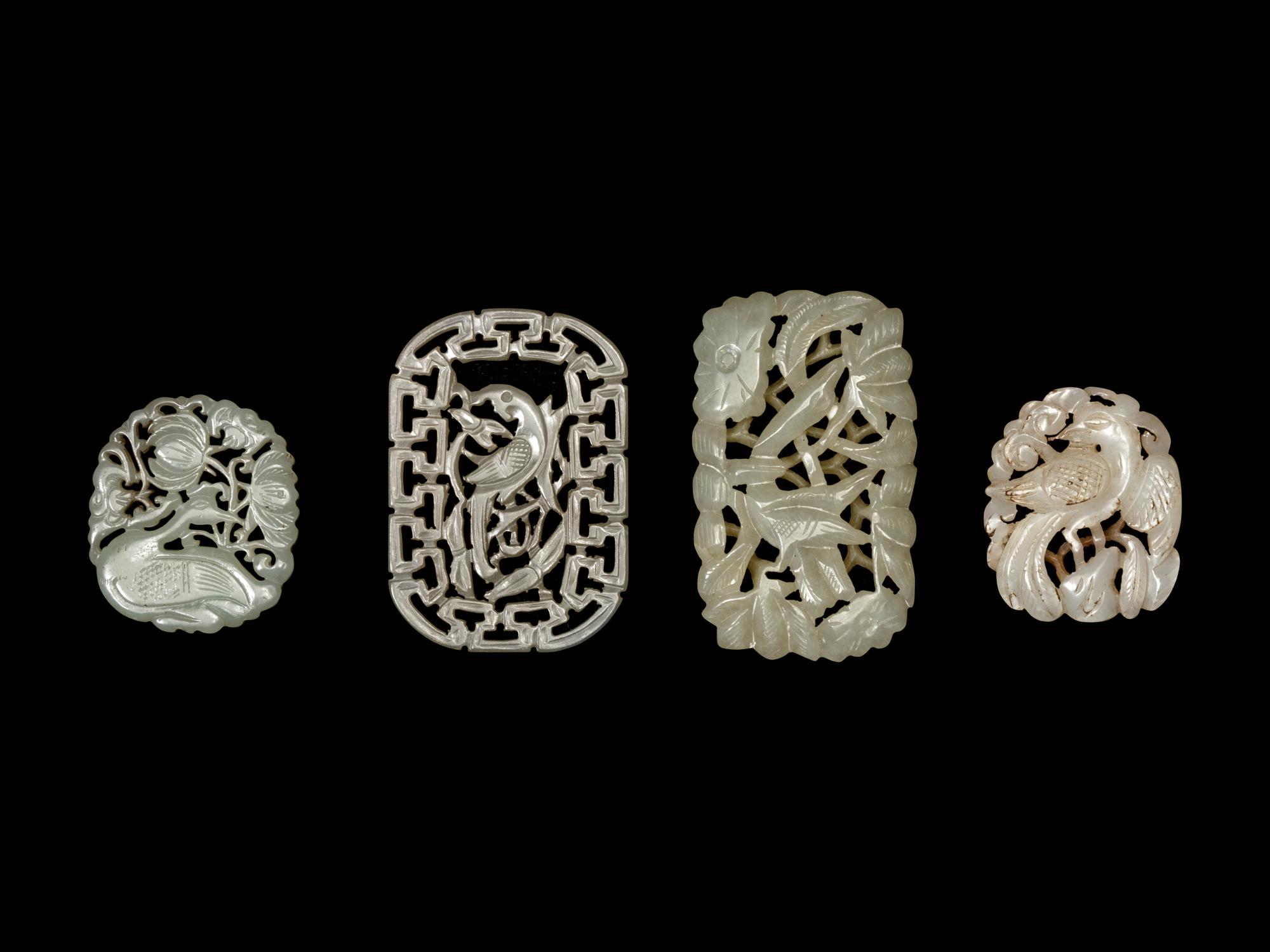 Four Chinese White and Celadon Jade Reticulated Pendants