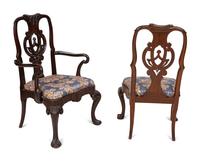 A Set of Twelve Continental Walnut Dining Chairs