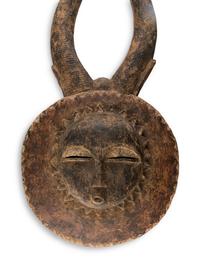 An African Carved Wood Horned Sun Mask