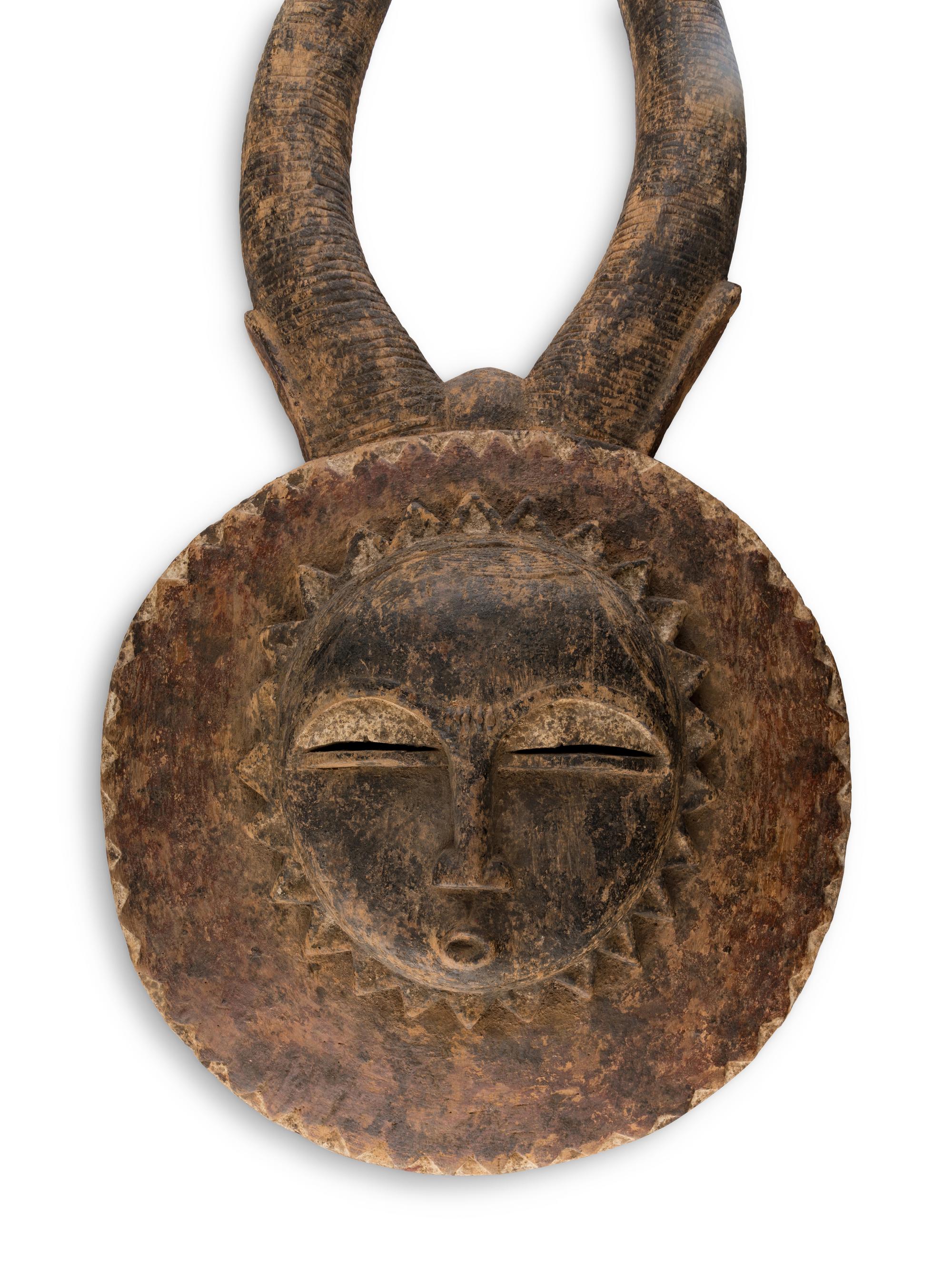 An African Carved Wood Horned Sun Mask