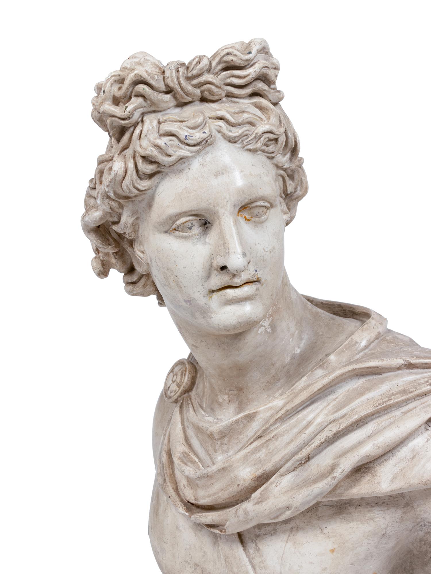 A Terracotta Bust of the Apollo Belvedere and an Acrylic Pedestal