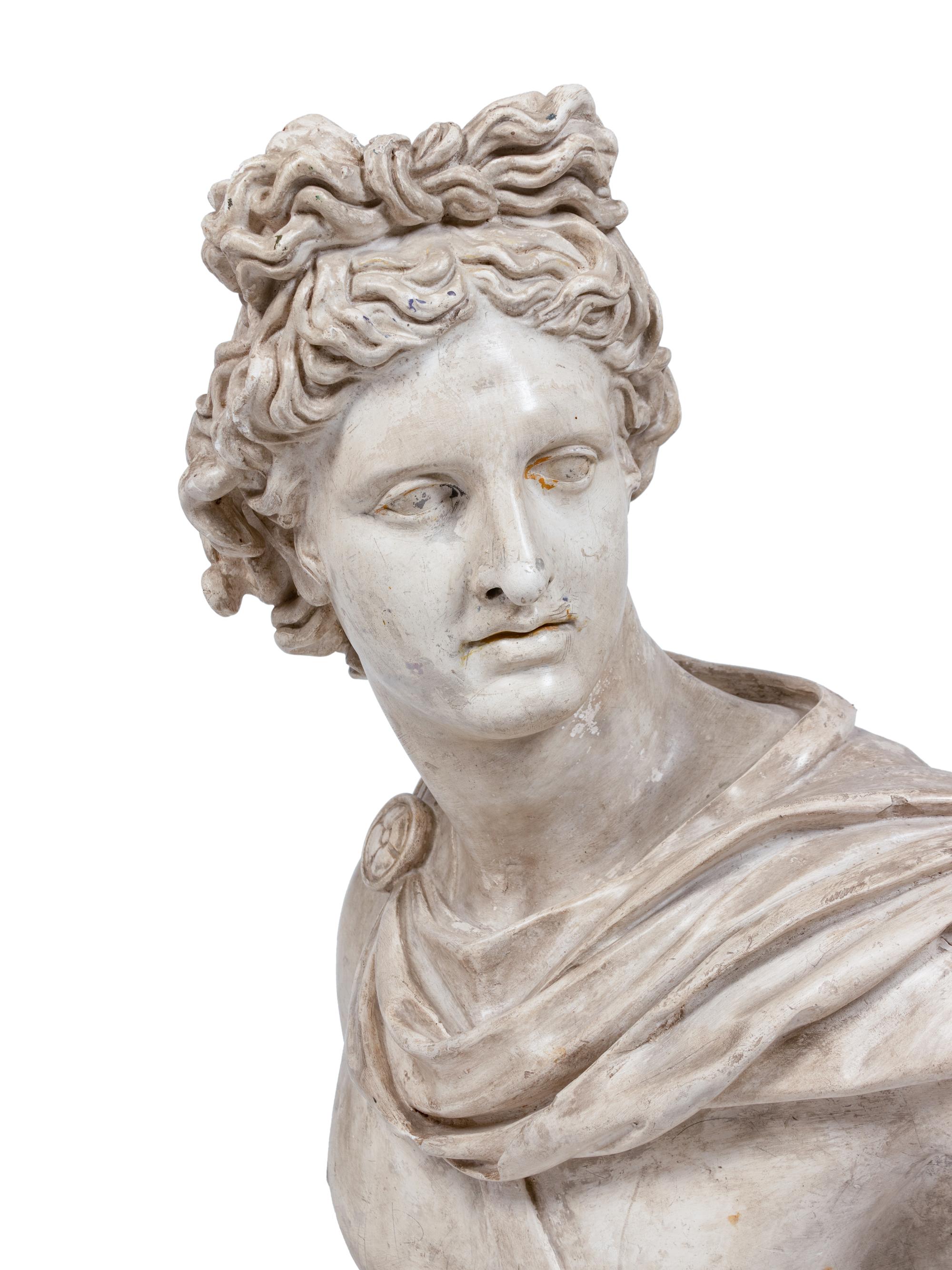 A Terracotta Bust of the Apollo Belvedere and an Acrylic Pedestal