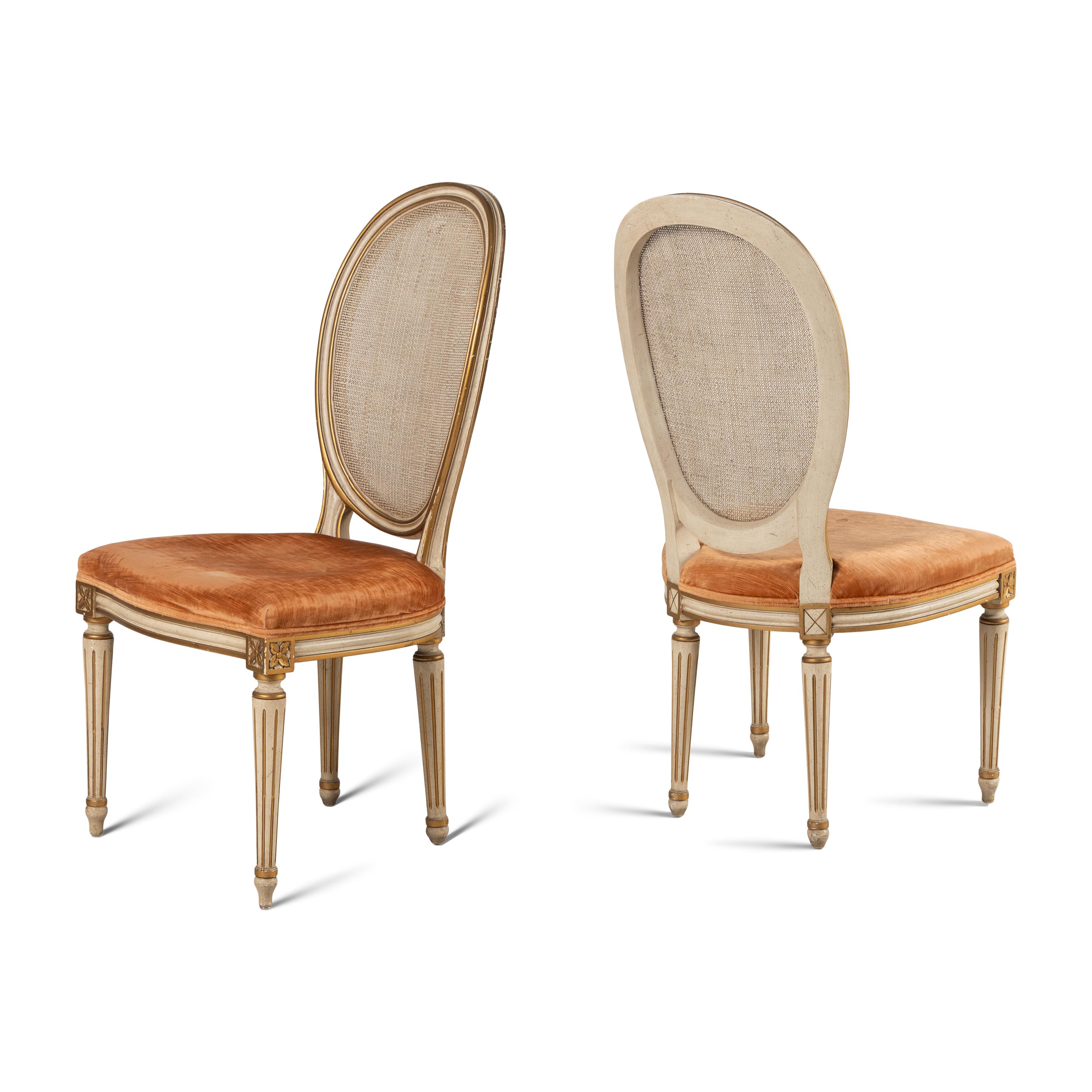 A Set of Eight Louis XVI Style Crème-Painted and Parcel Gilt Dining Chairs