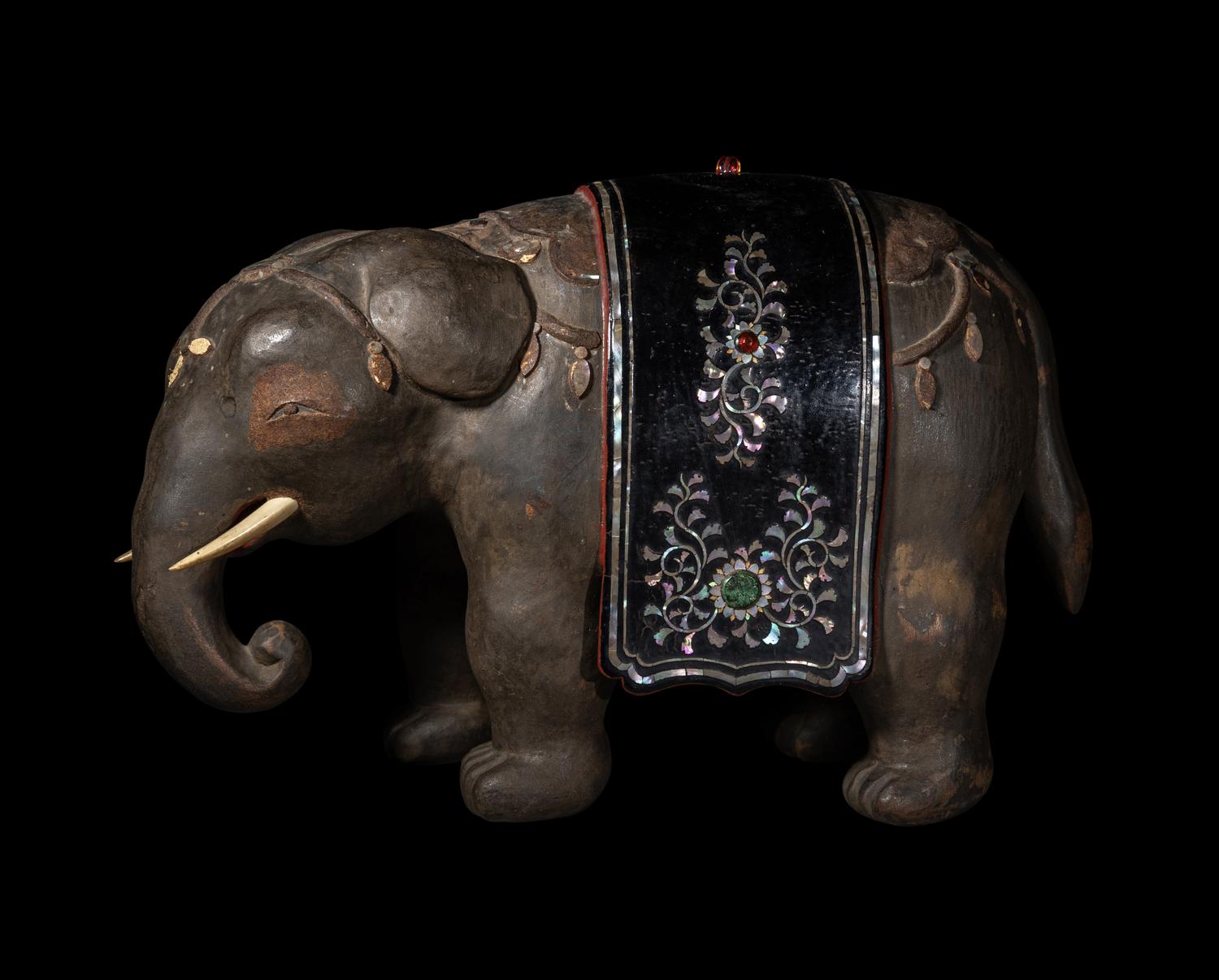 A Japanese Mother-of-Pearl Inlaid Lacquered Wood Okimono of an Elephant