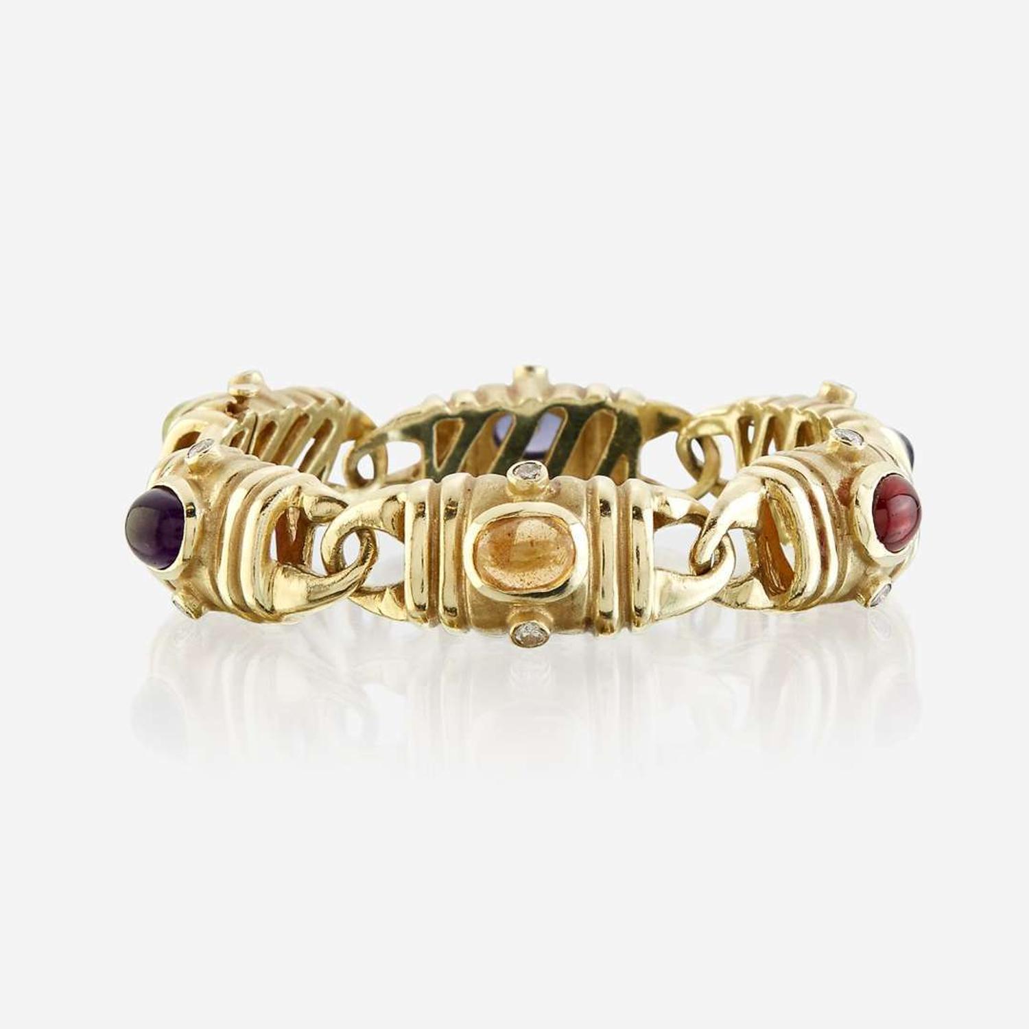 A fourteen karat gold and gem-set bracelet