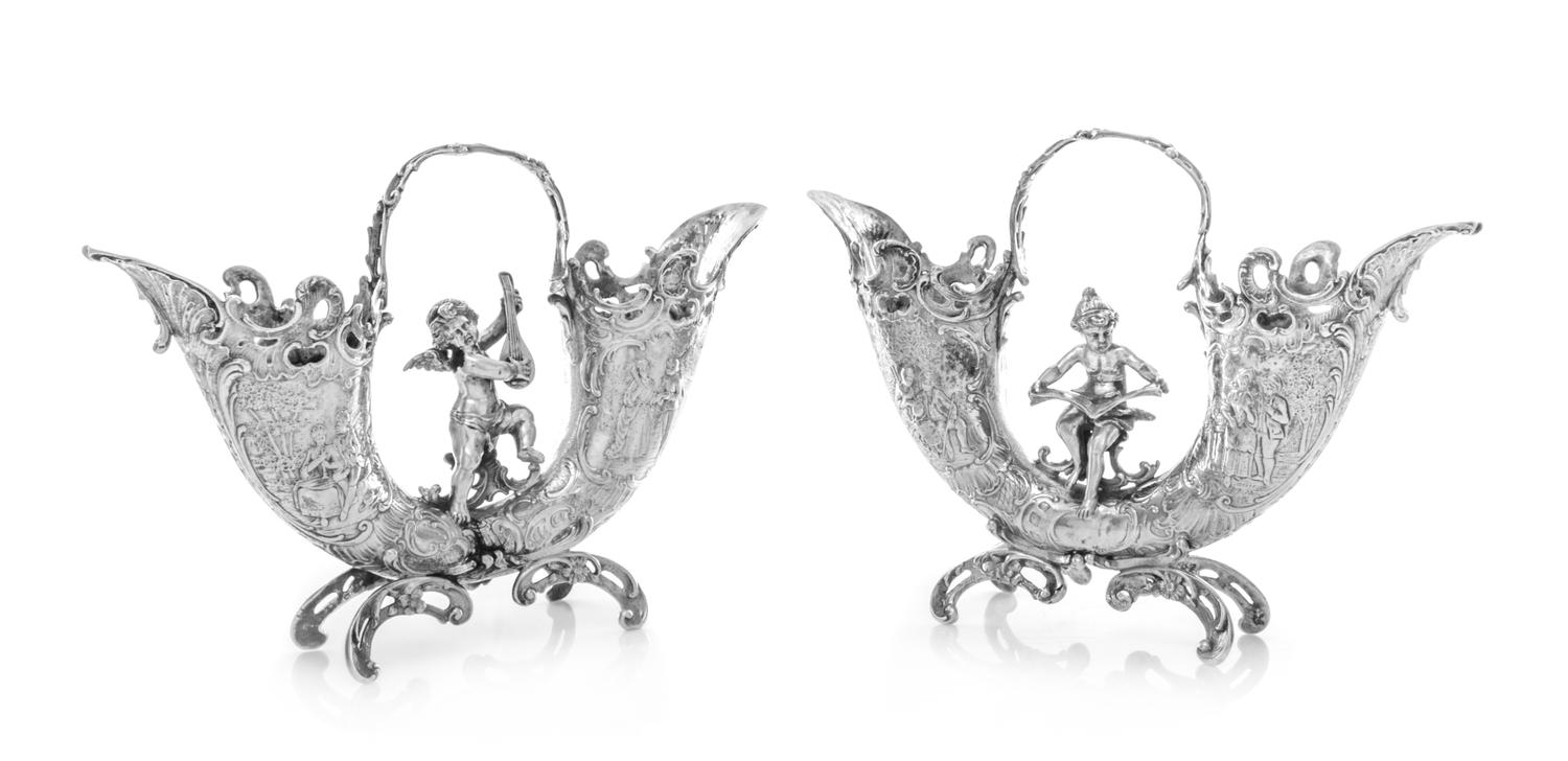 A Pair of Continental Silver-Plate Table Ornaments, Likely German, the U-form vases worked with rocaille and foliate rims, the bodies d