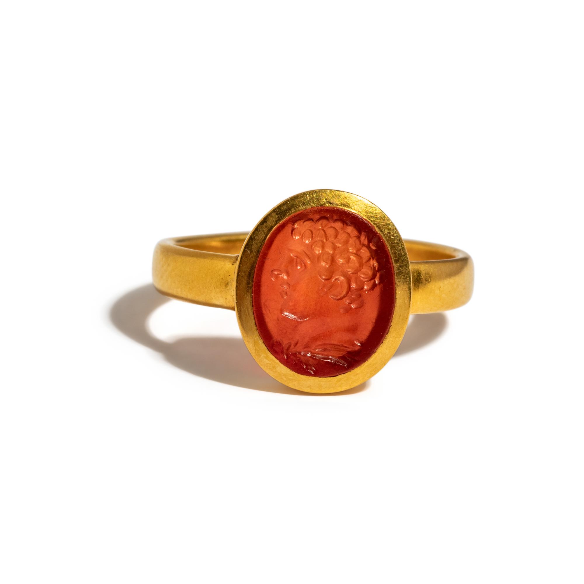 A Roman Carnelian Ring Stone with the Portrait Head of a Young Hercules — Set in a gold ring