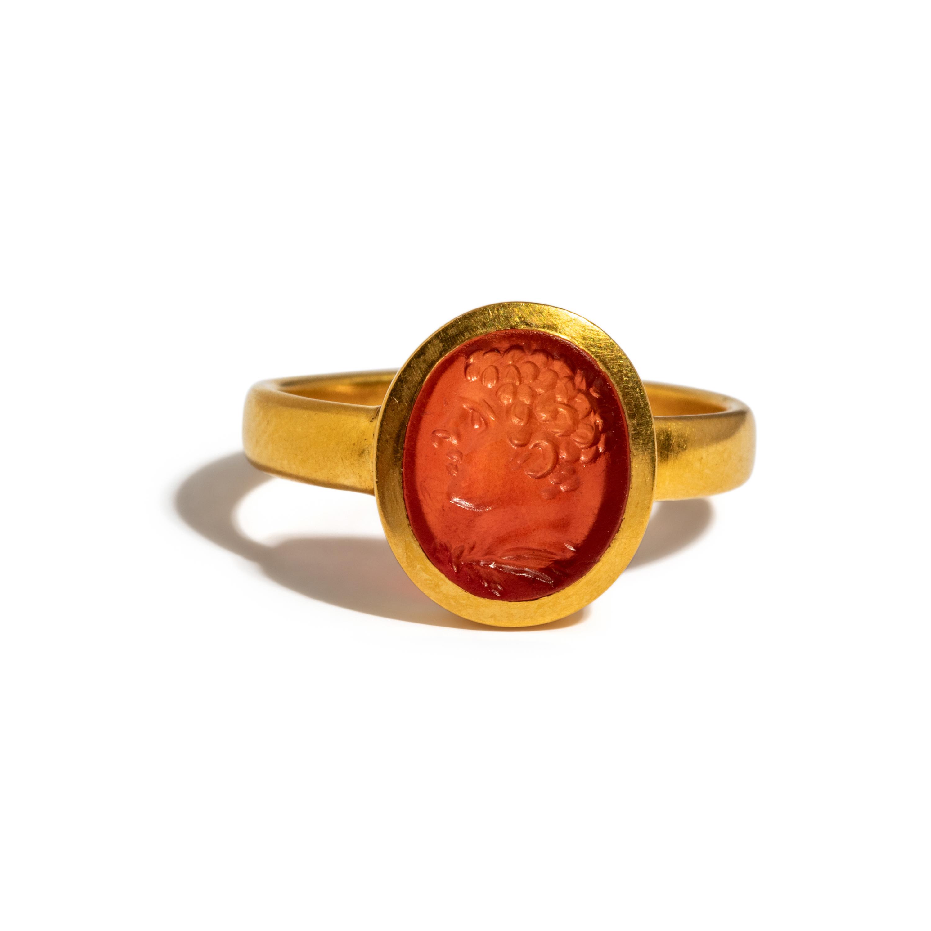A Roman Carnelian Ring Stone with the Portrait Head of a Young Hercules — Set in a gold ring