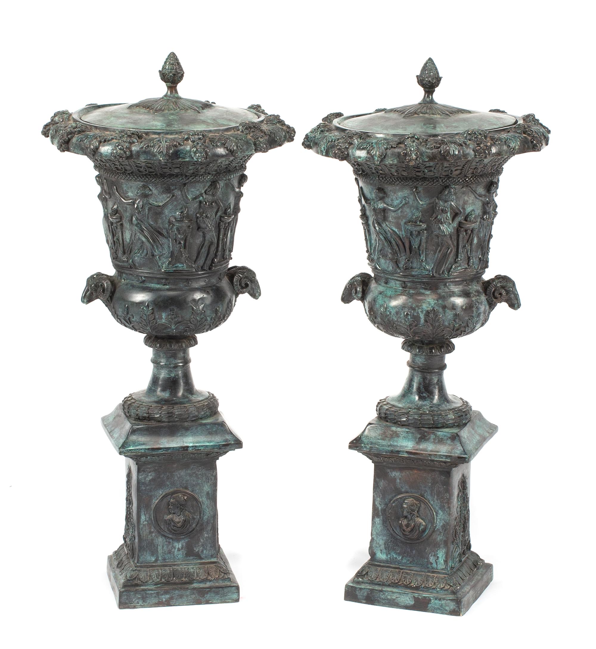 A Pair of Pompeiian Style Patinated Bronze Covered Urns Height 31 1/2 inches.