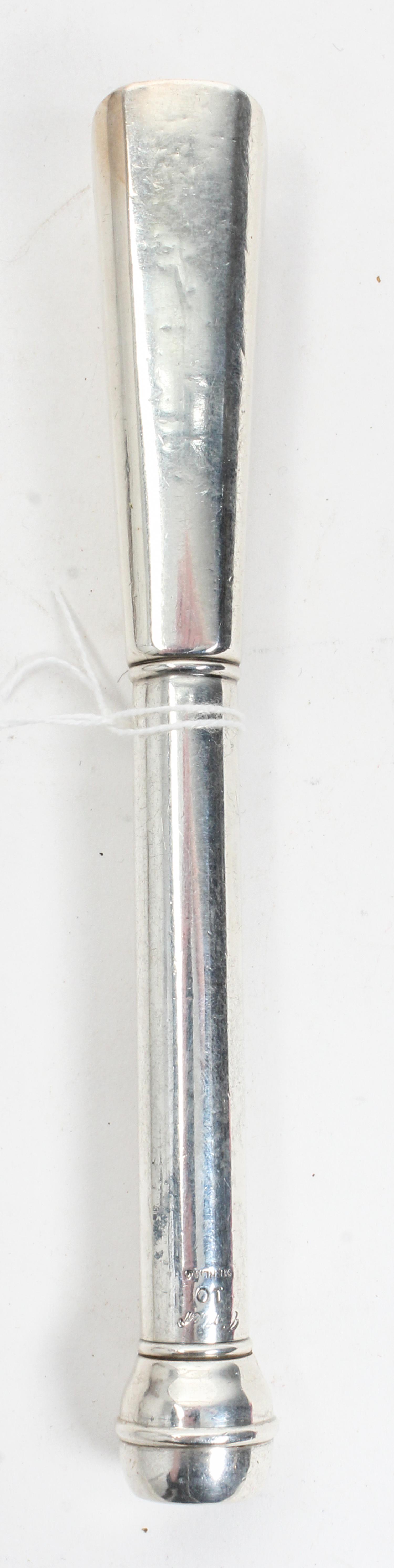 A Cartier Silver Muddler, New York, NY, the tapering square handle with canted corners surmounting a cylindrical stem with a bell-shape