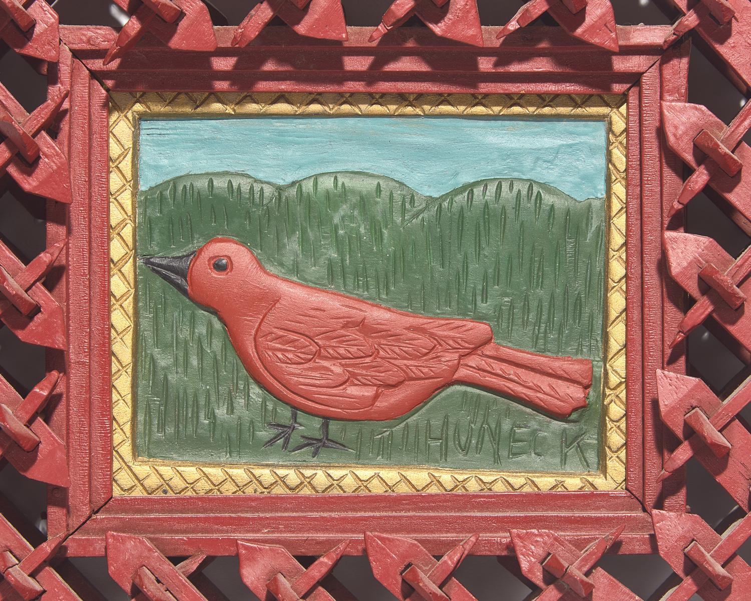 Stephen Huneck (1948-2010), A Carved and Painted Wood Plaque of a Bird in Painted Tramp Art Frame