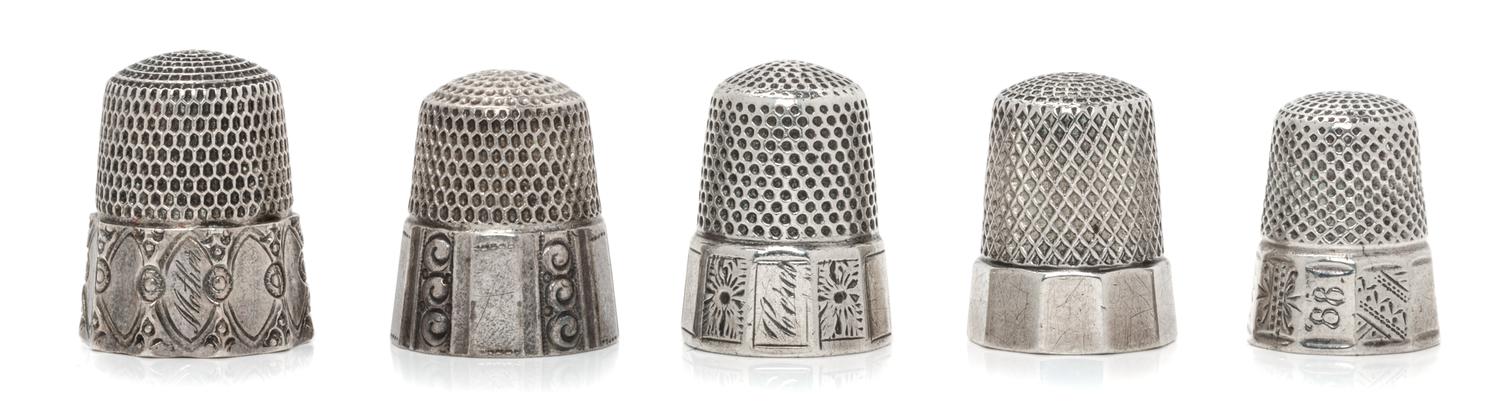 Five Silver Thimbles, Simons Bros., Philadelphia, PA and others, each having a knurled top and body above a paneled base.