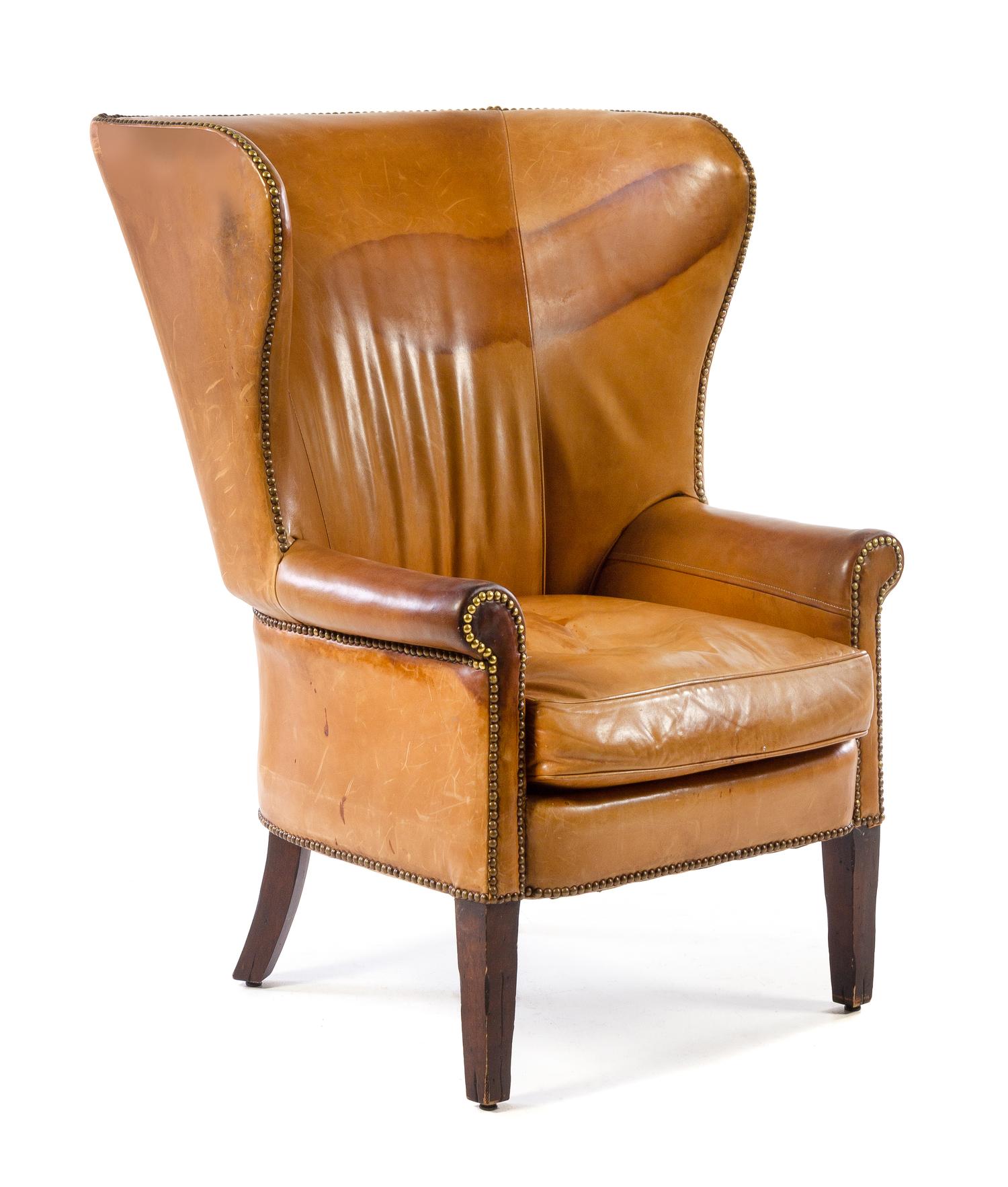 A George III Style Leather-Upholstered Wingback Chair Height 45 1/4 x width 32 3/4 x depth 35 inches. — LATE 19TH/EARLY 20TH CENTURY