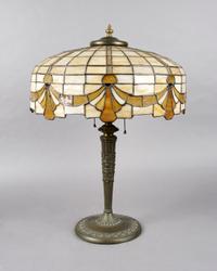 An American Leaded Glass Lamp, Diameter of shade 16 1/2 inches, height overall 23 inches.