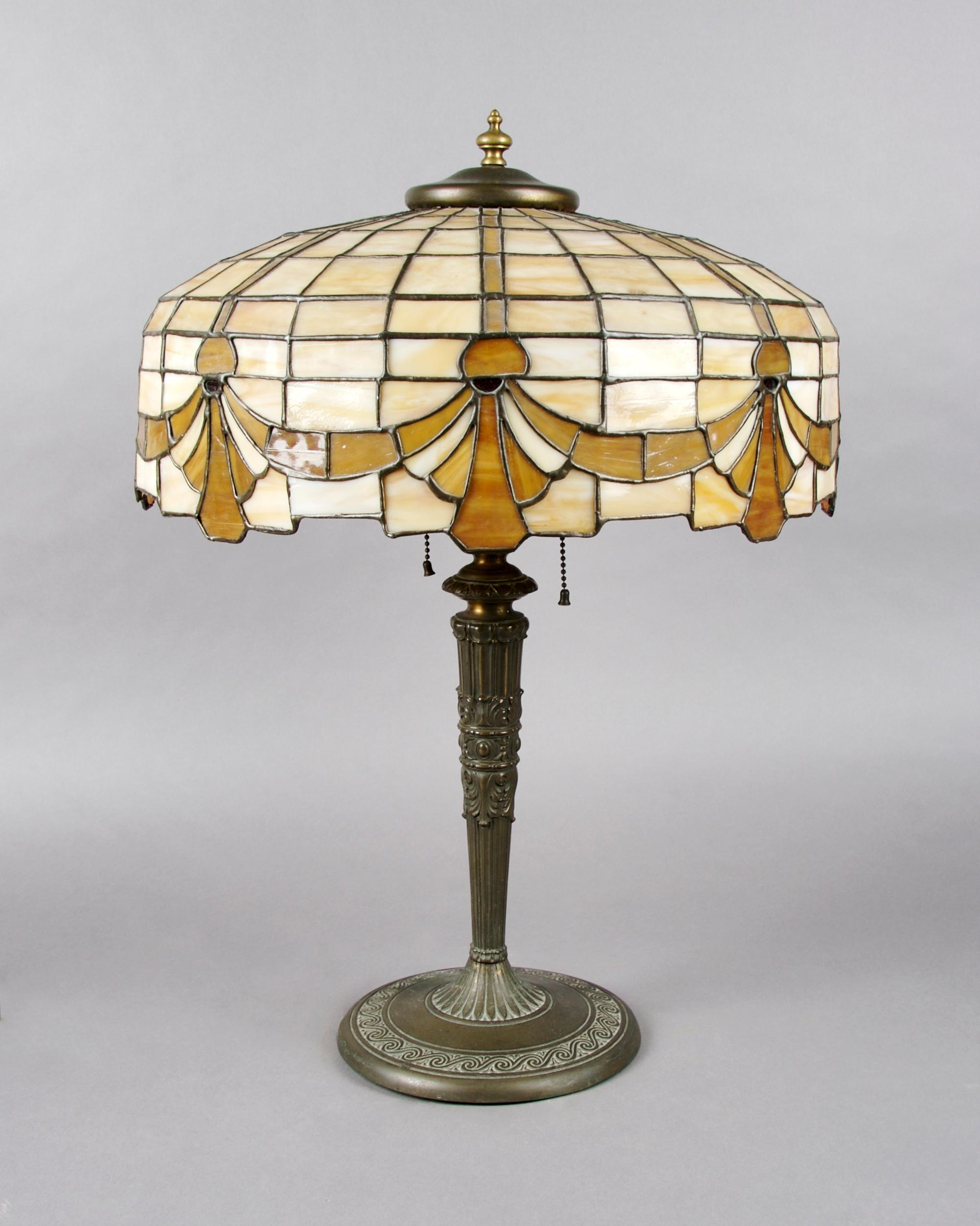 An American Leaded Glass Lamp, Diameter of shade 16 1/2 inches, height overall 23 inches.