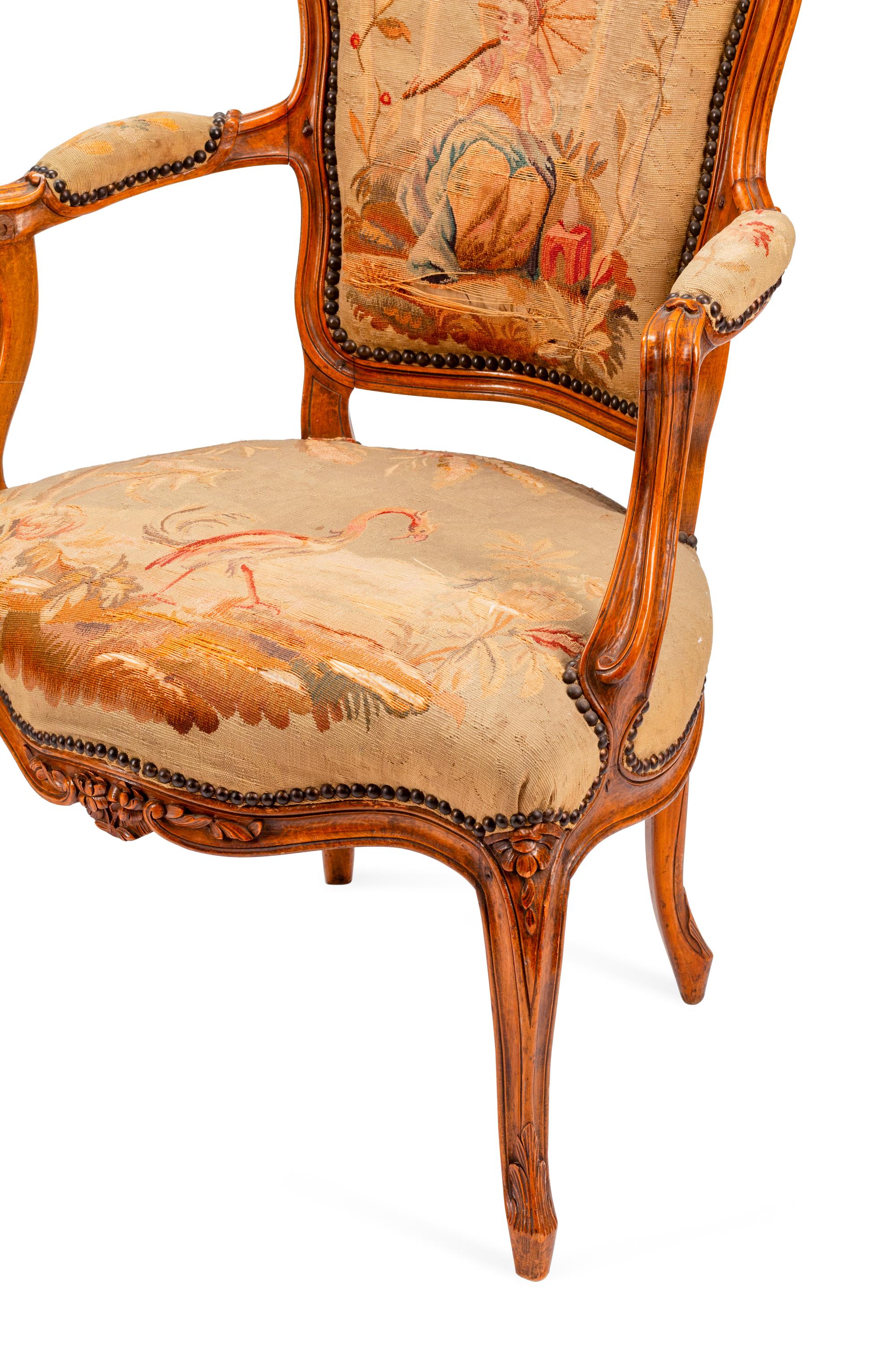 A Pair of Louis XV Tapestry-Upholstered Walnut Fauteuils