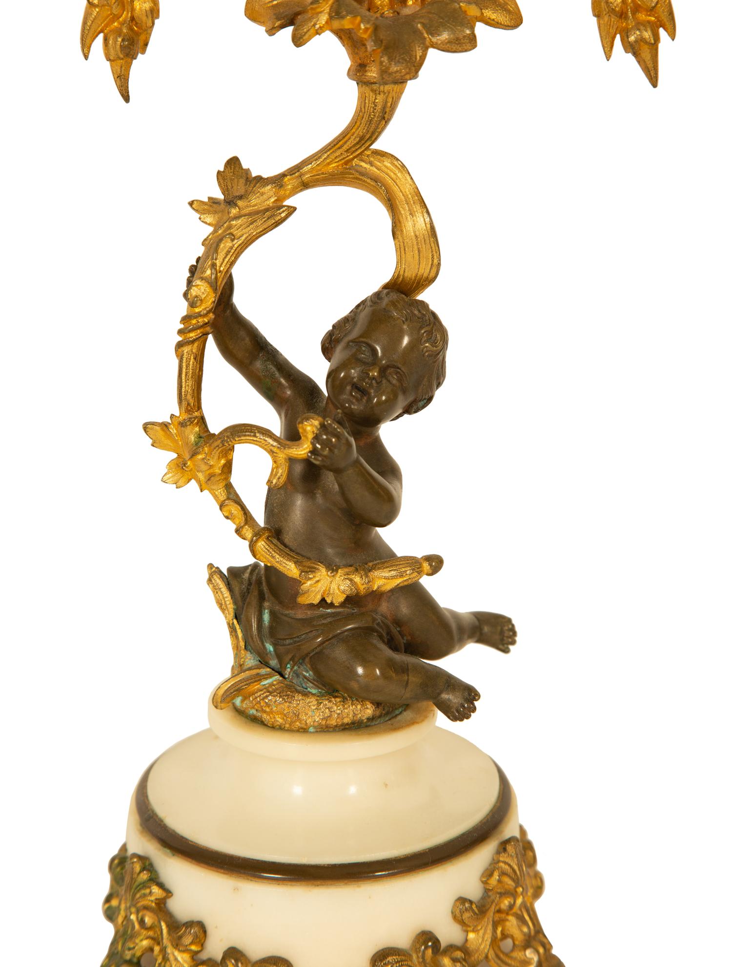A Pair of Gilt and Patinated Bronze Figural Three-Light Candelabra