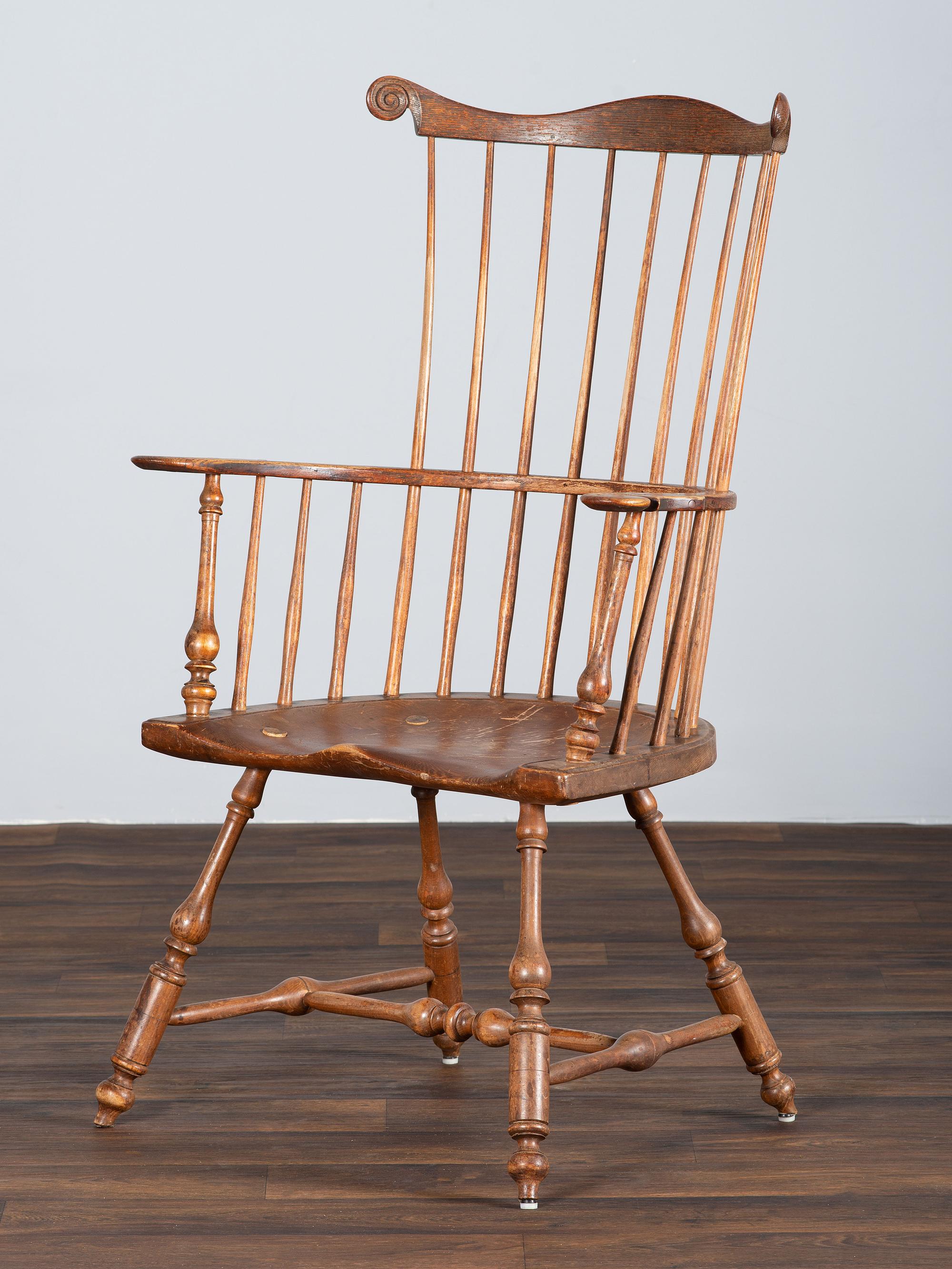 A Volute and Scroll Carved and Reel Turned Windsor Armchair