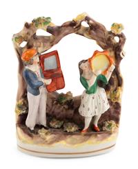 A Group of Fourteen Street Organist Figurines