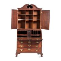 A Chippendale Carved and Paneled Mahogany Slant-Front Desk-and-Bookcase