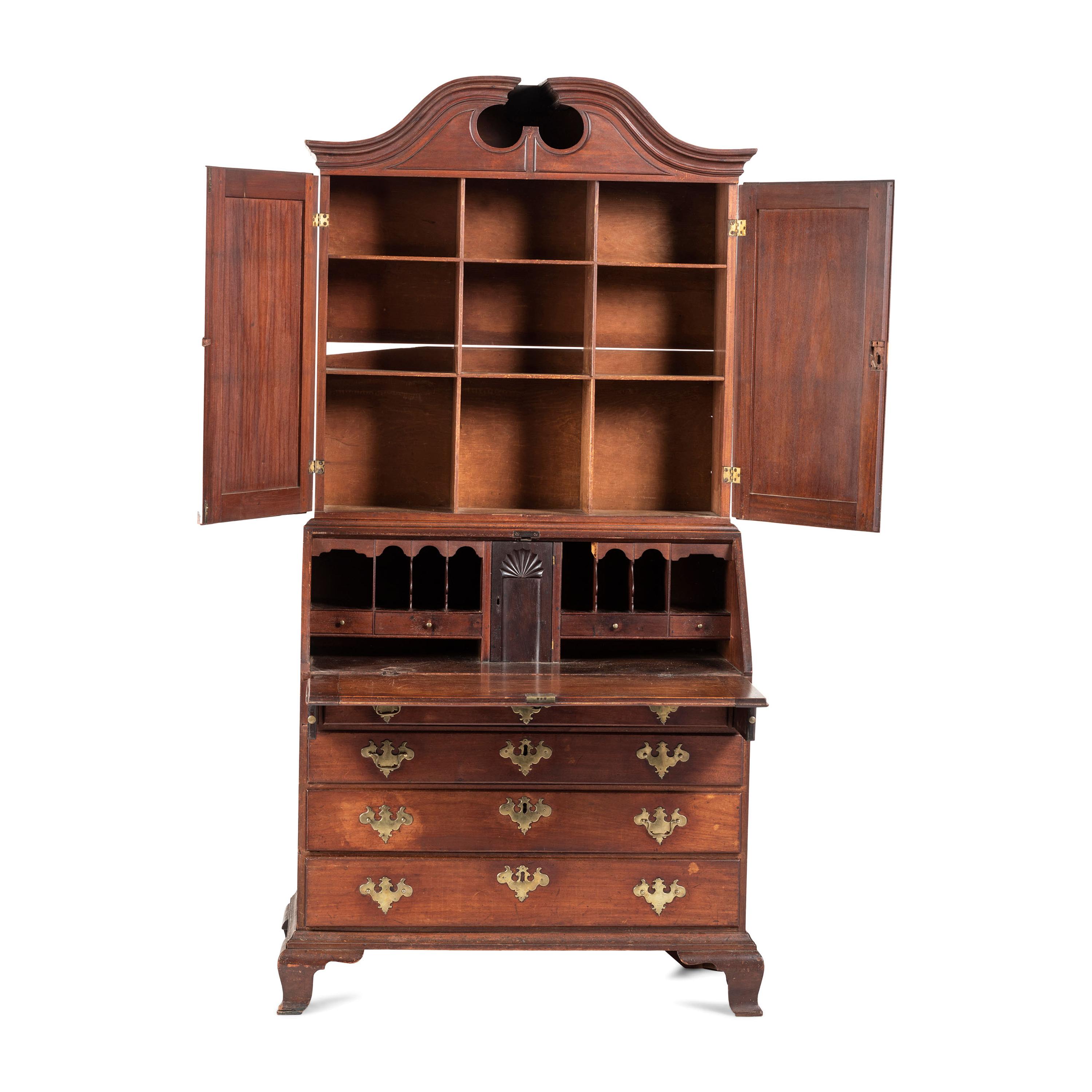 A Chippendale Carved and Paneled Mahogany Slant-Front Desk-and-Bookcase