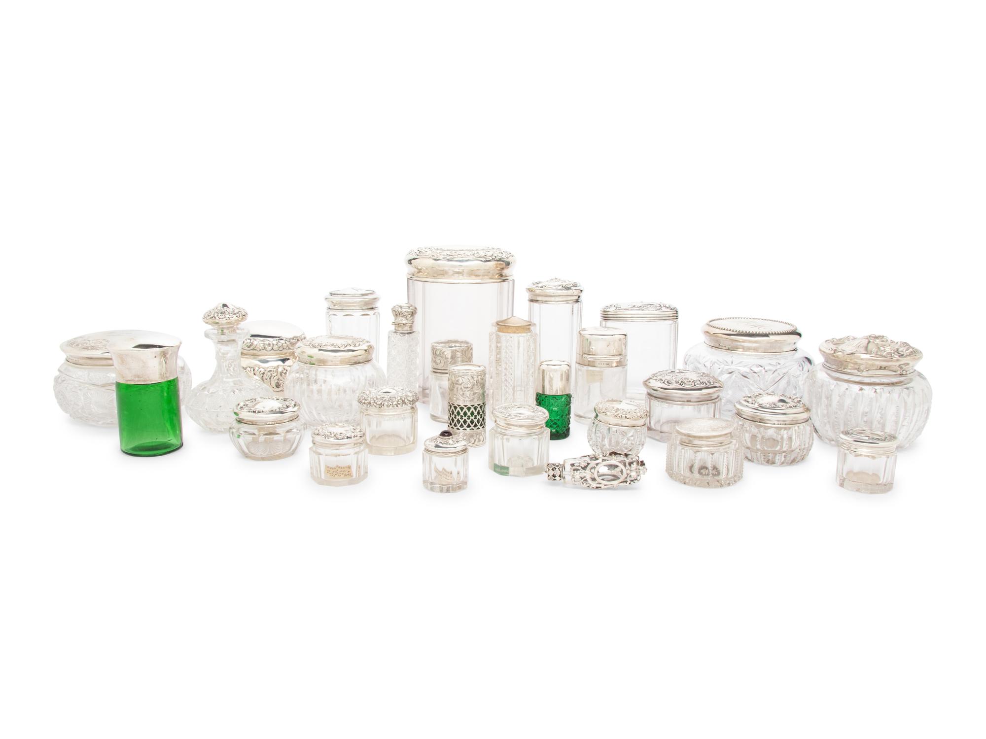 A Collection of Silver Mounted Glass Scent Bottles and Vanity Jars