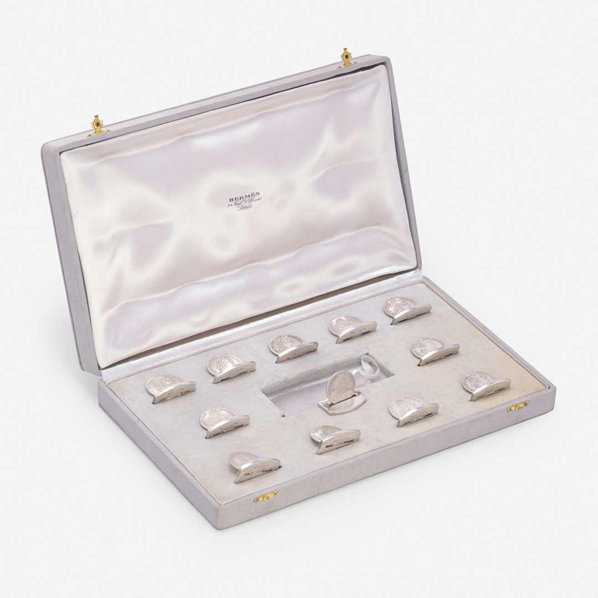 A Cased Set of Twelve French Silver Place Card Holders Ravinet Louis & Denfert Charles, retailed by Hermès, Paris, mid 20th century