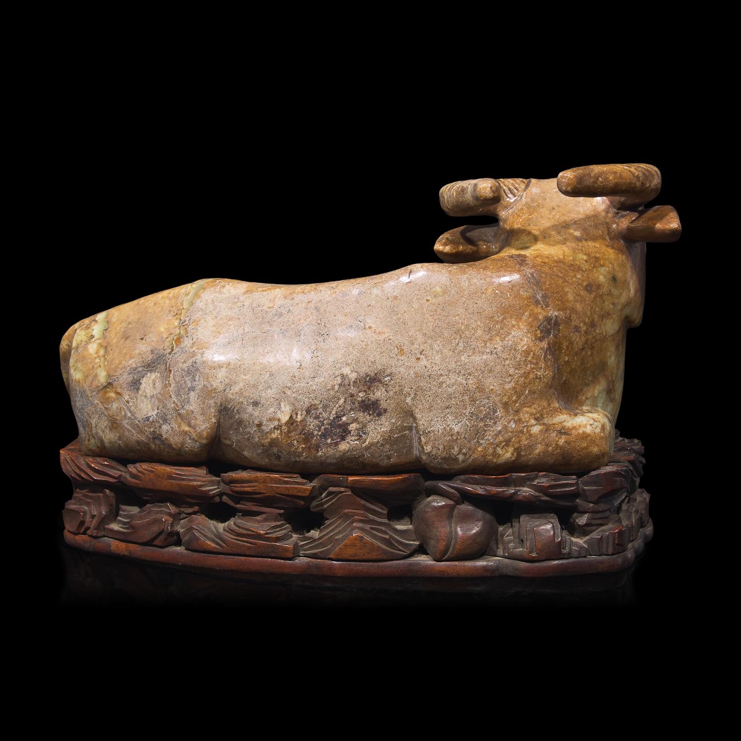 A Large Chinese Celadon and Beige Jade Buffalo, 18th/19th Century 清中期 青玉臥牛