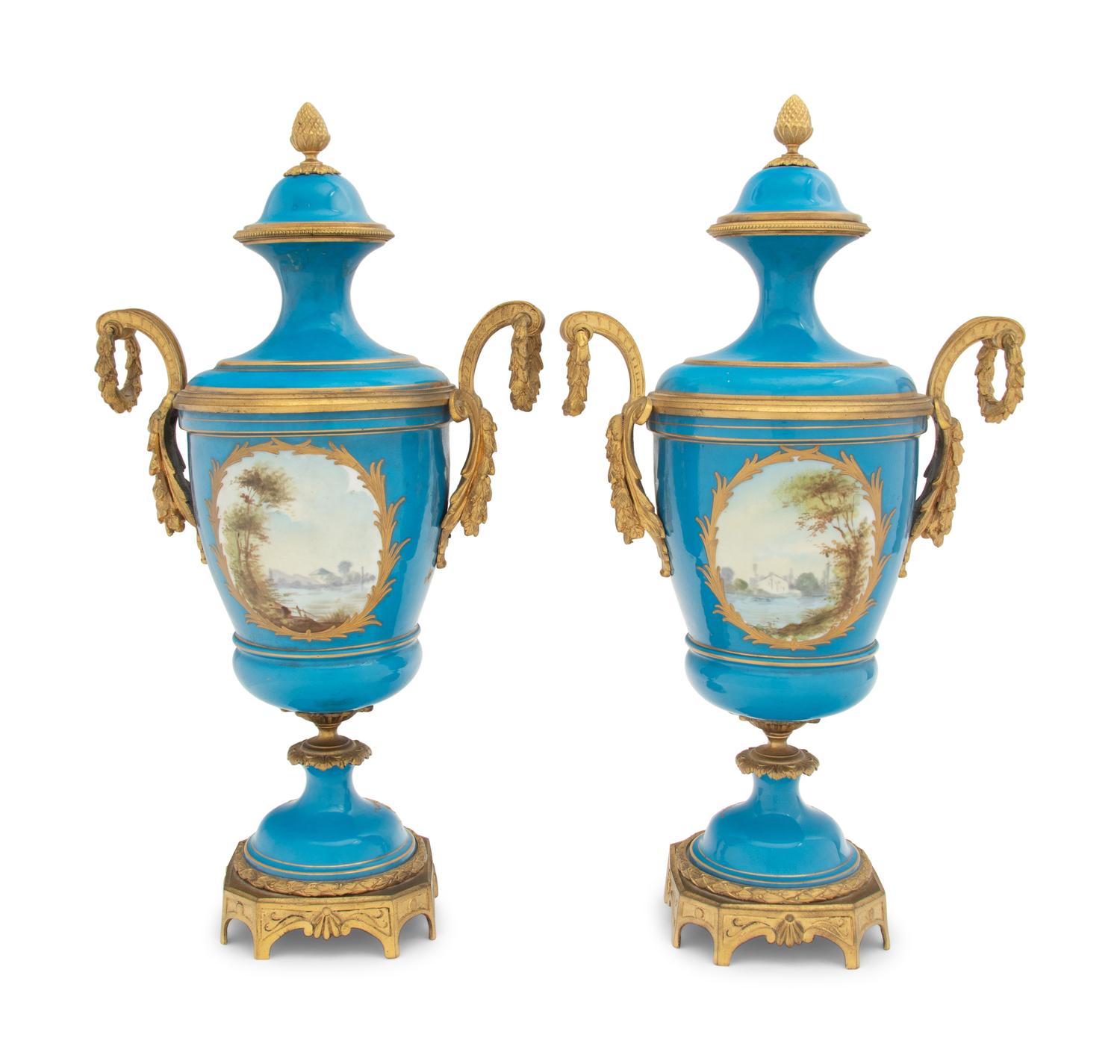 A Pair of Sèvres Style Gilt Bronze Mounted Porcelain Urns
