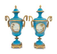A Pair of Sèvres Style Gilt Bronze Mounted Porcelain Urns