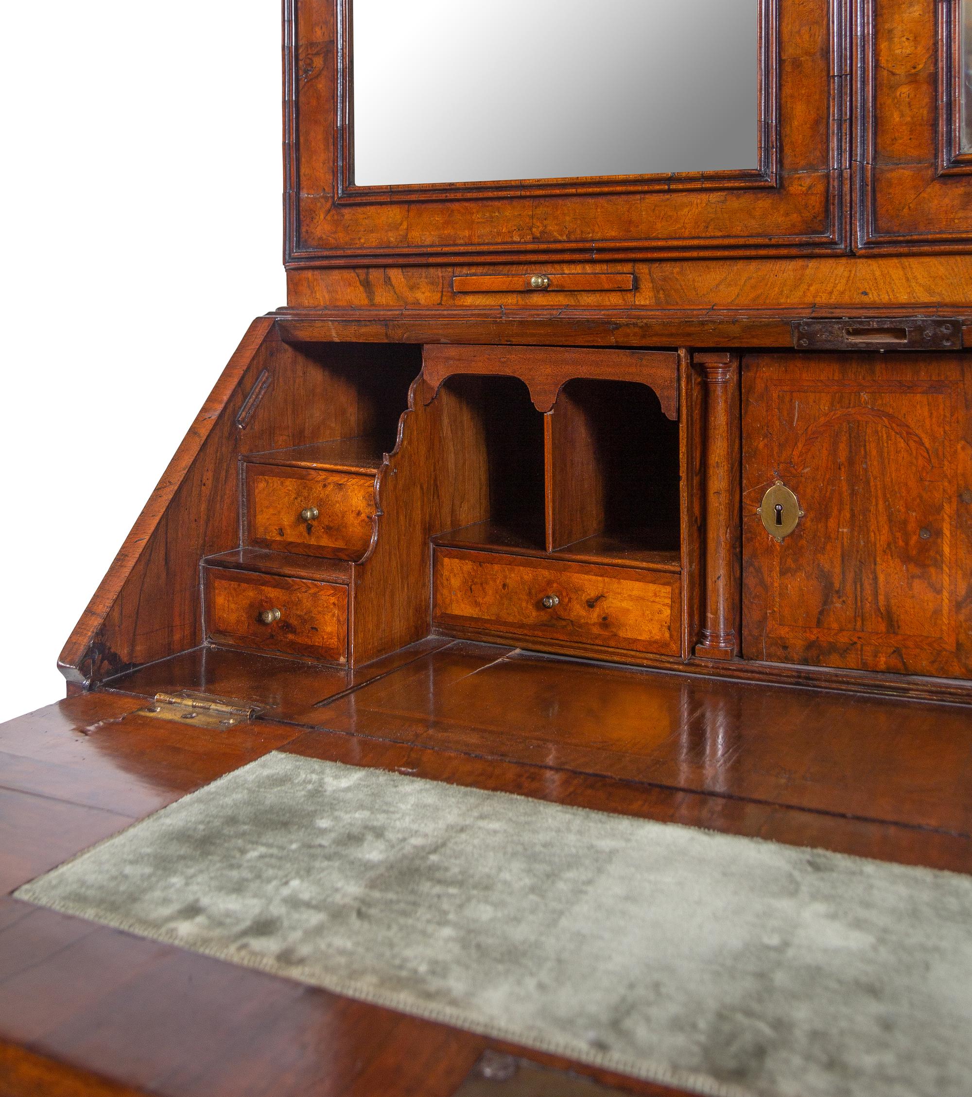 A George I Carved Burl Walnut Double-Dome Bureau Bookcase