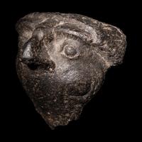 An Egyptian Basalt Falcon Face Fragment