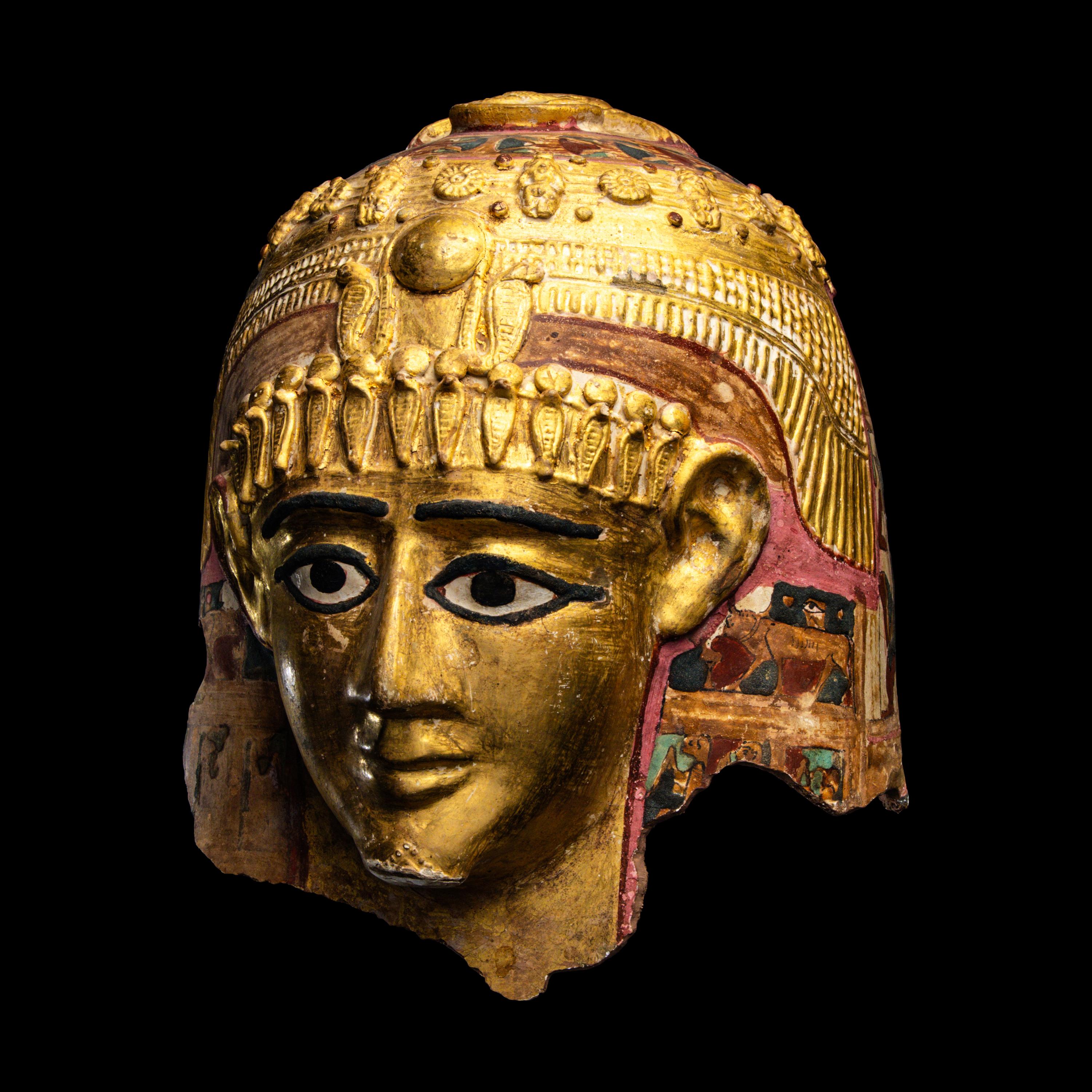 An Egyptian Gilt Cartonnage Mummy Mask of a Woman
