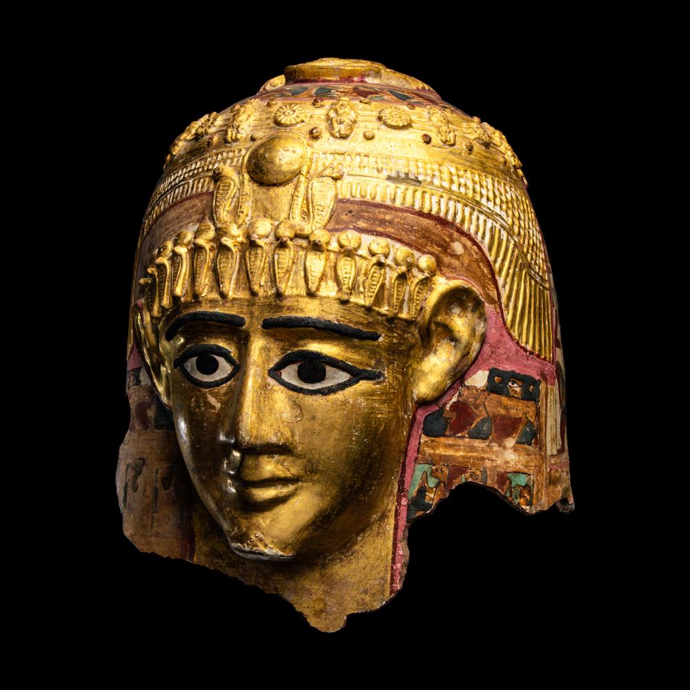 An Egyptian Gilt Cartonnage Mummy Mask of a Woman