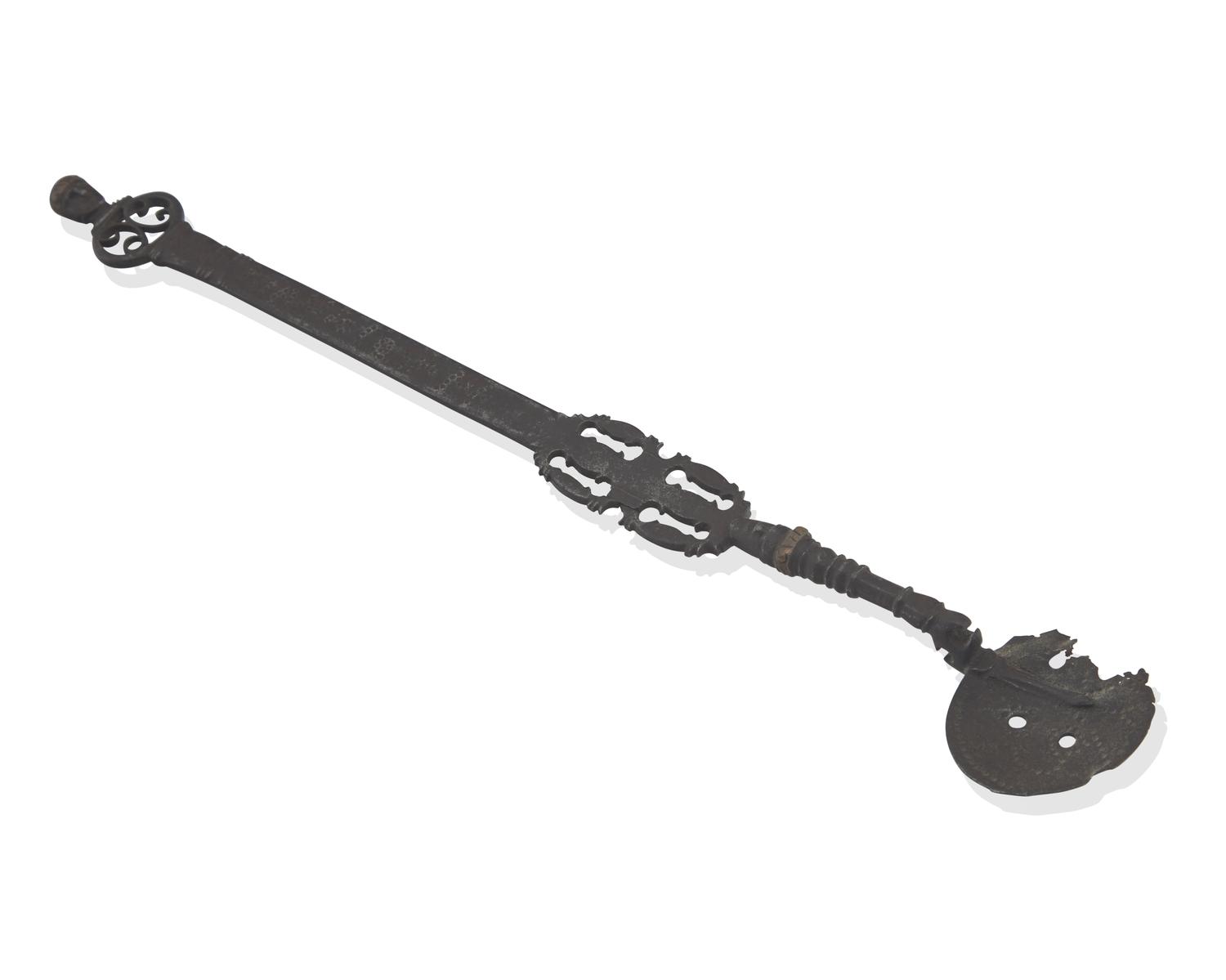 A Copper-Inlaid Wrought Iron Slotted Spoon with Human Head-Form Terminals