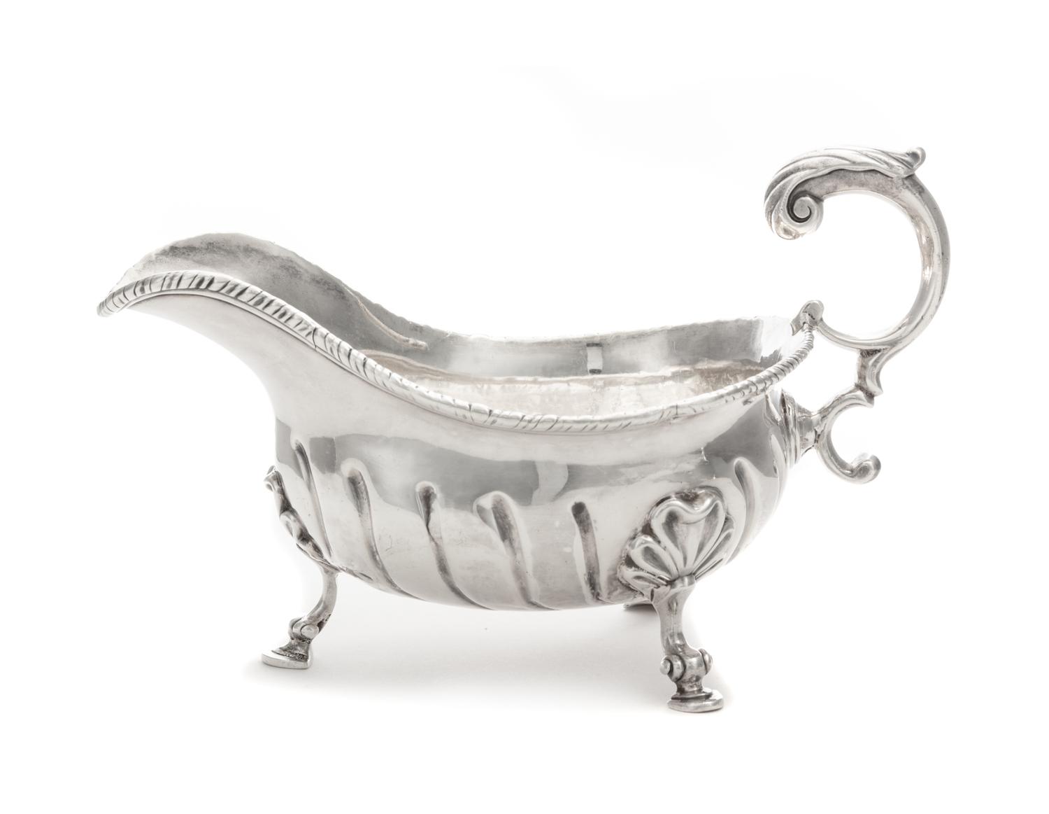 A George II Silver Sauce Boat, Robert Innes, London, 1756, with a gadrooned rim and an applied S-scroll handle, the body with impressed