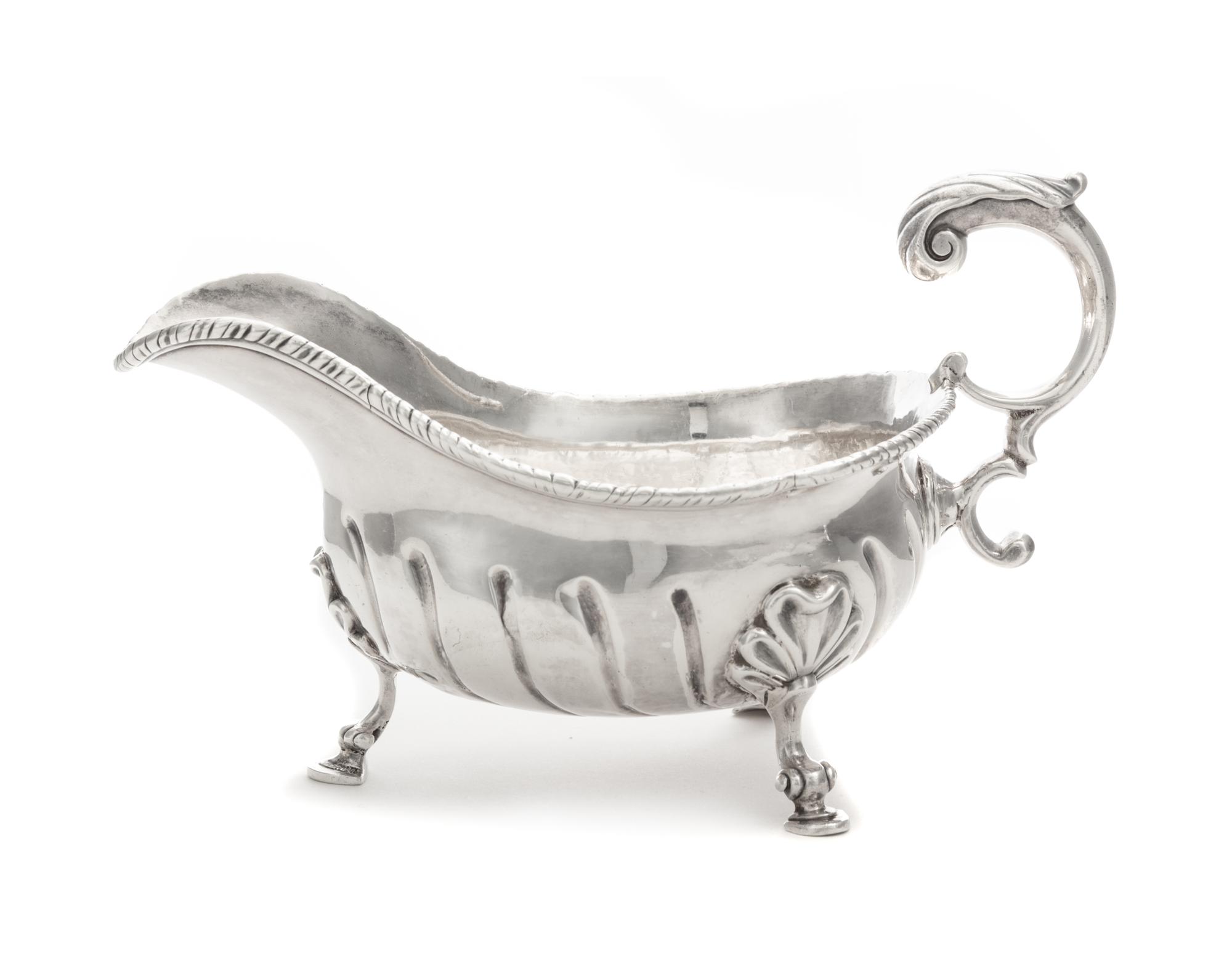 A George II Silver Sauce Boat, Robert Innes, London, 1756, with a gadrooned rim and an applied S-scroll handle, the body with impressed