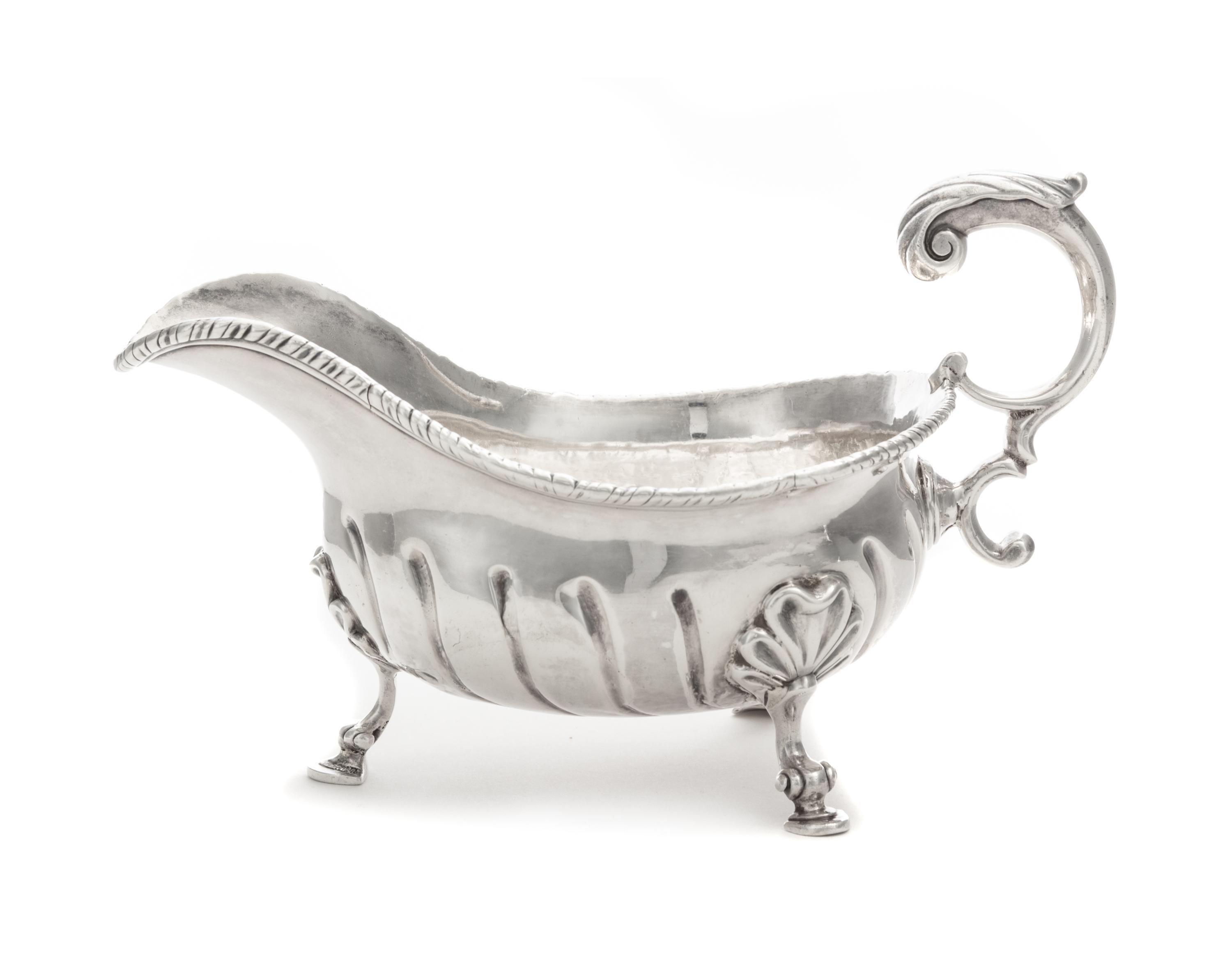 A George II Silver Sauce Boat, Robert Innes, London, 1756, with a gadrooned rim and an applied S-scroll handle, the body with impressed