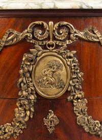 A Louis XV Style Gilt Metal Mounted Figured Walnut Commode