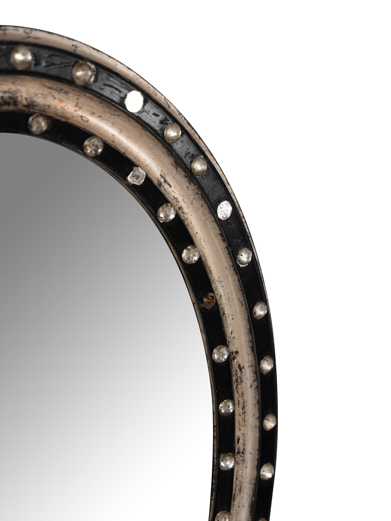 An Irish Ebonized and Part-Silvered Oval Mirror