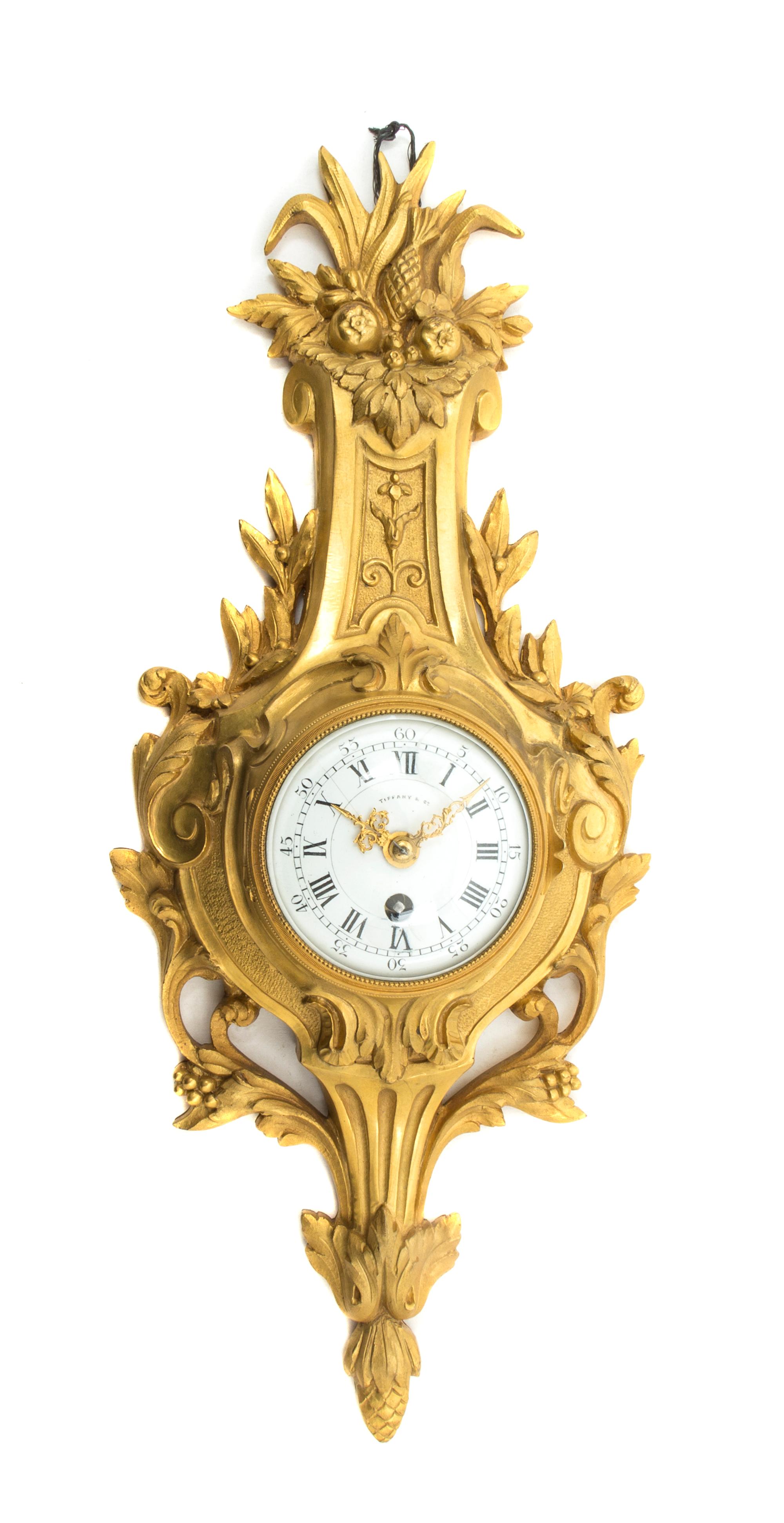 A French Gilt Bronze Diminutive Cartel Clock, retailed by Tiffany & Co., Height 14 1/8 inches.
