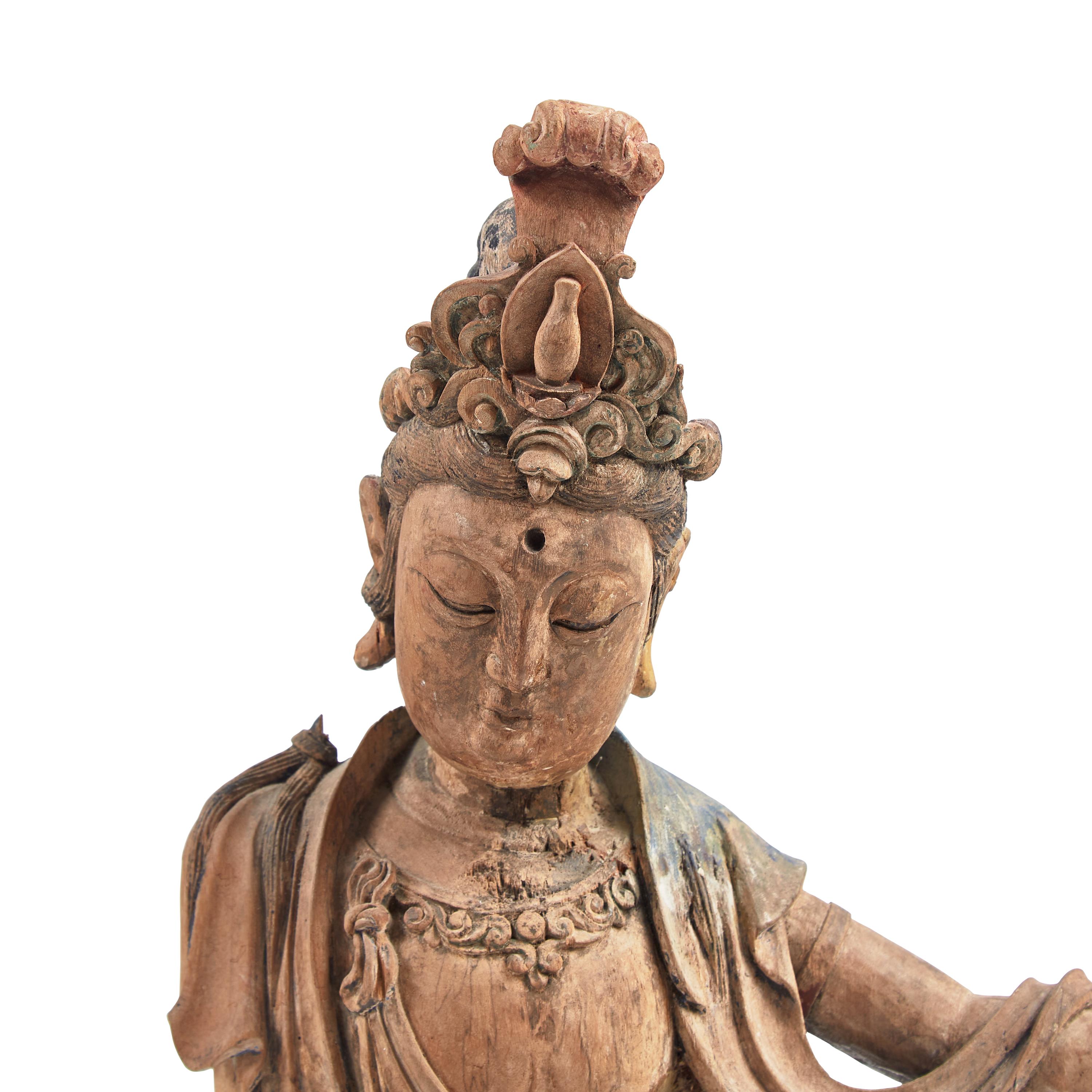 A Chinese Carved and Painted Wood Figure of Guanyin, Ming Dynasty or Earlier 明或更早 木雕彩繪水月觀音