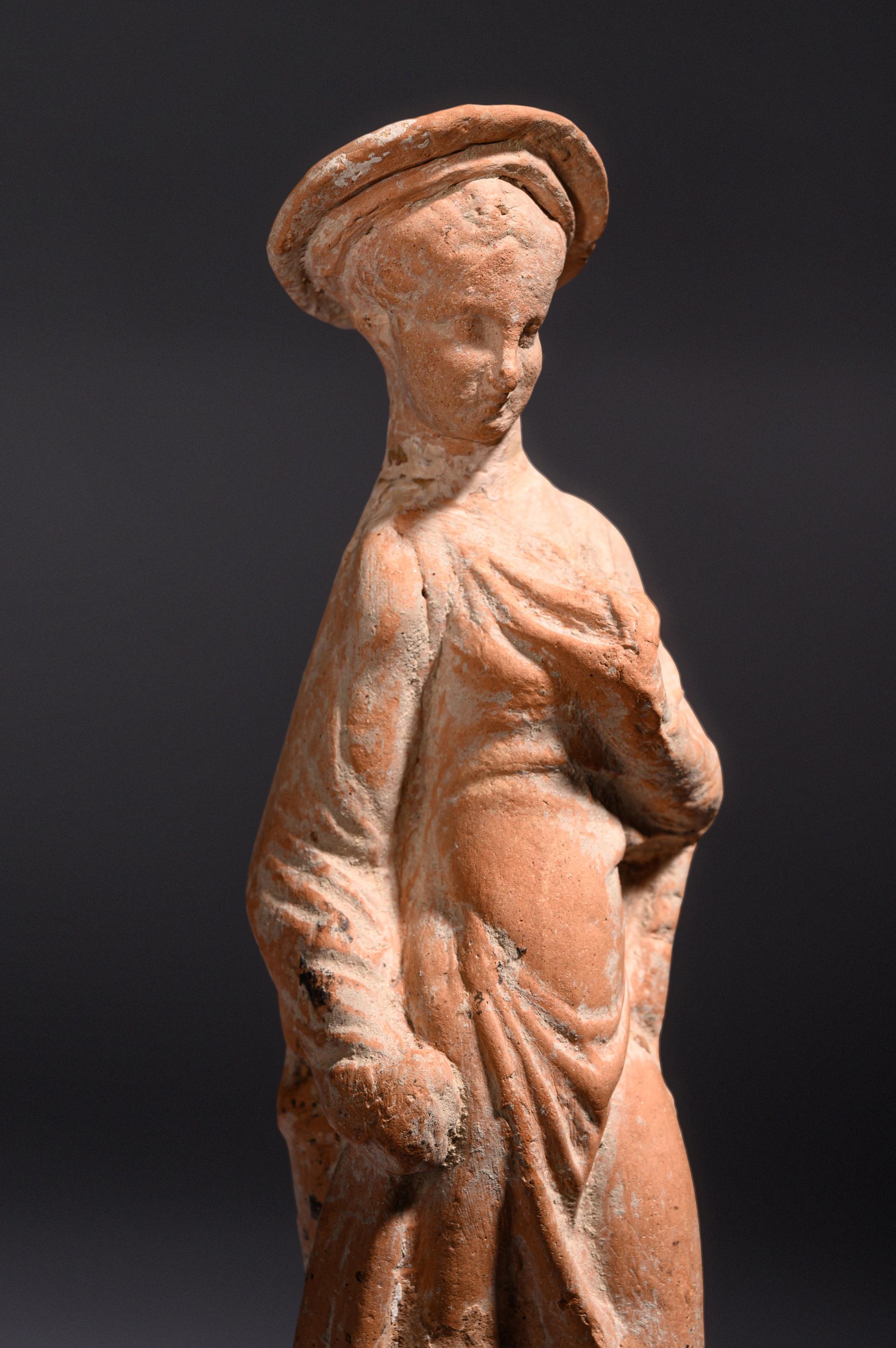 A Greek Terracotta Woman Wearing a Polos (broad-rimmed hat)