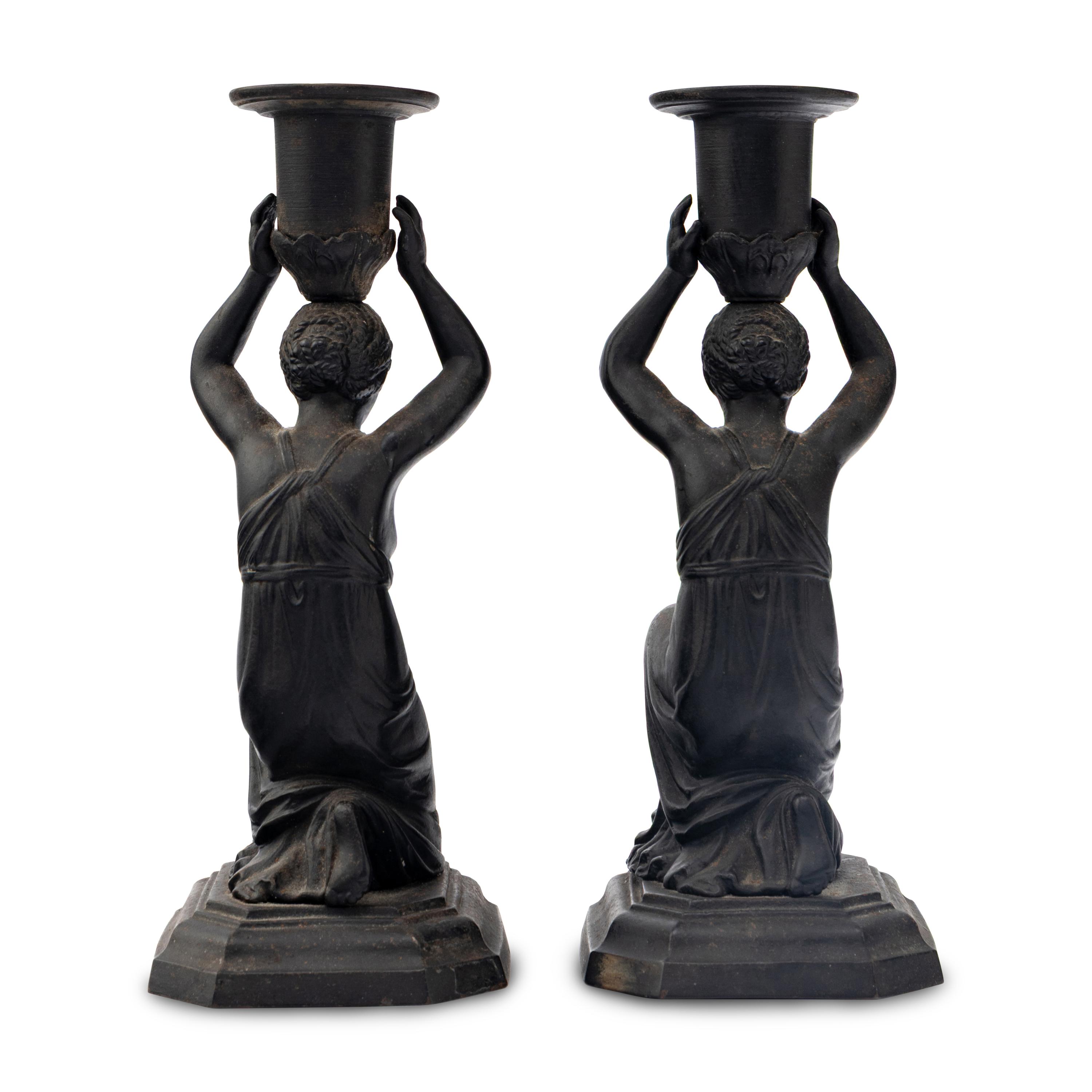 A Pair of Grand Tour Patinated Metal Figural Candlesticks